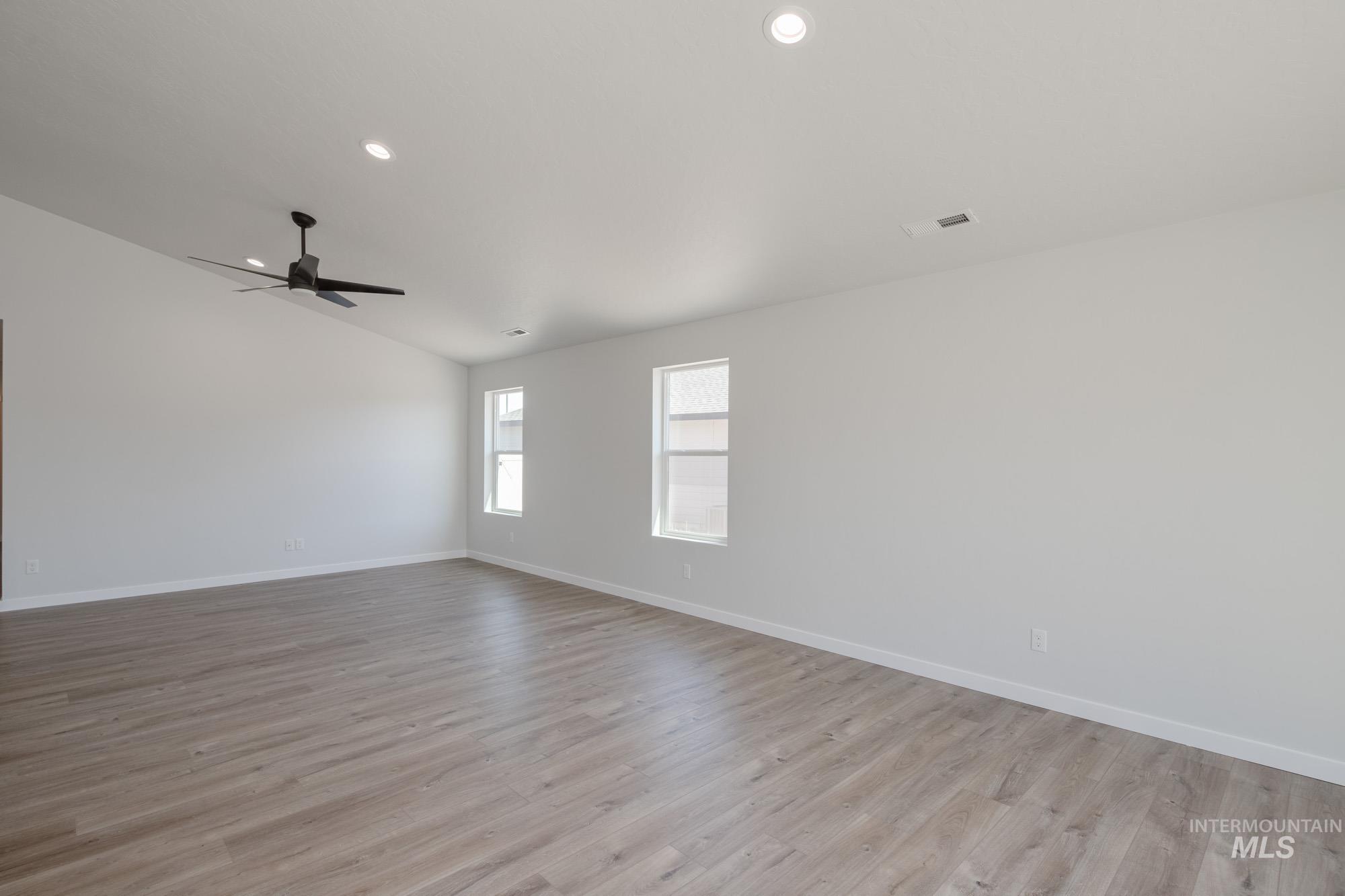 Unfurnished room with light wood-style flooring, recessed lighting, lofted ceiling, and ceiling fan