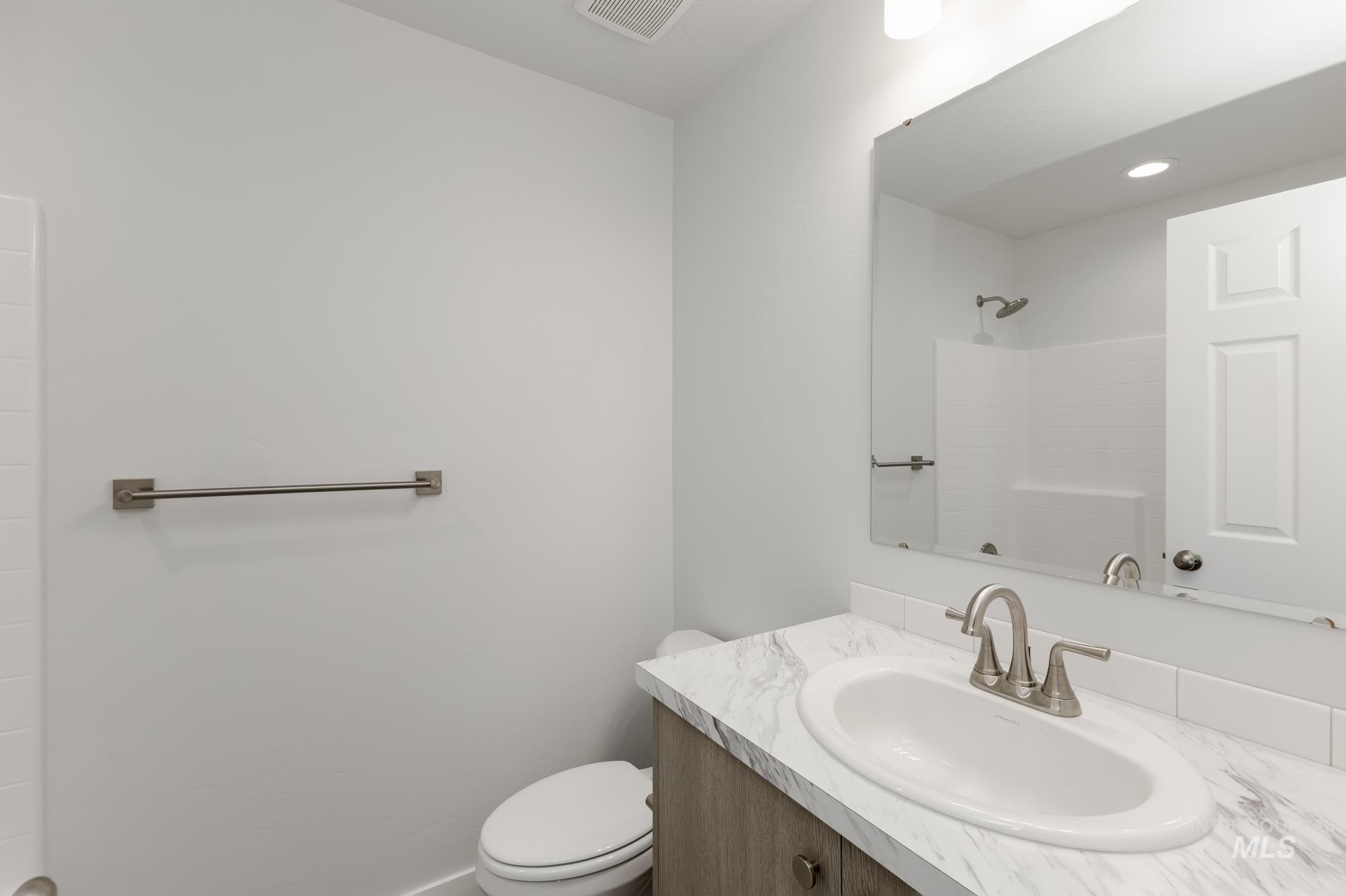Bathroom with vanity and a shower