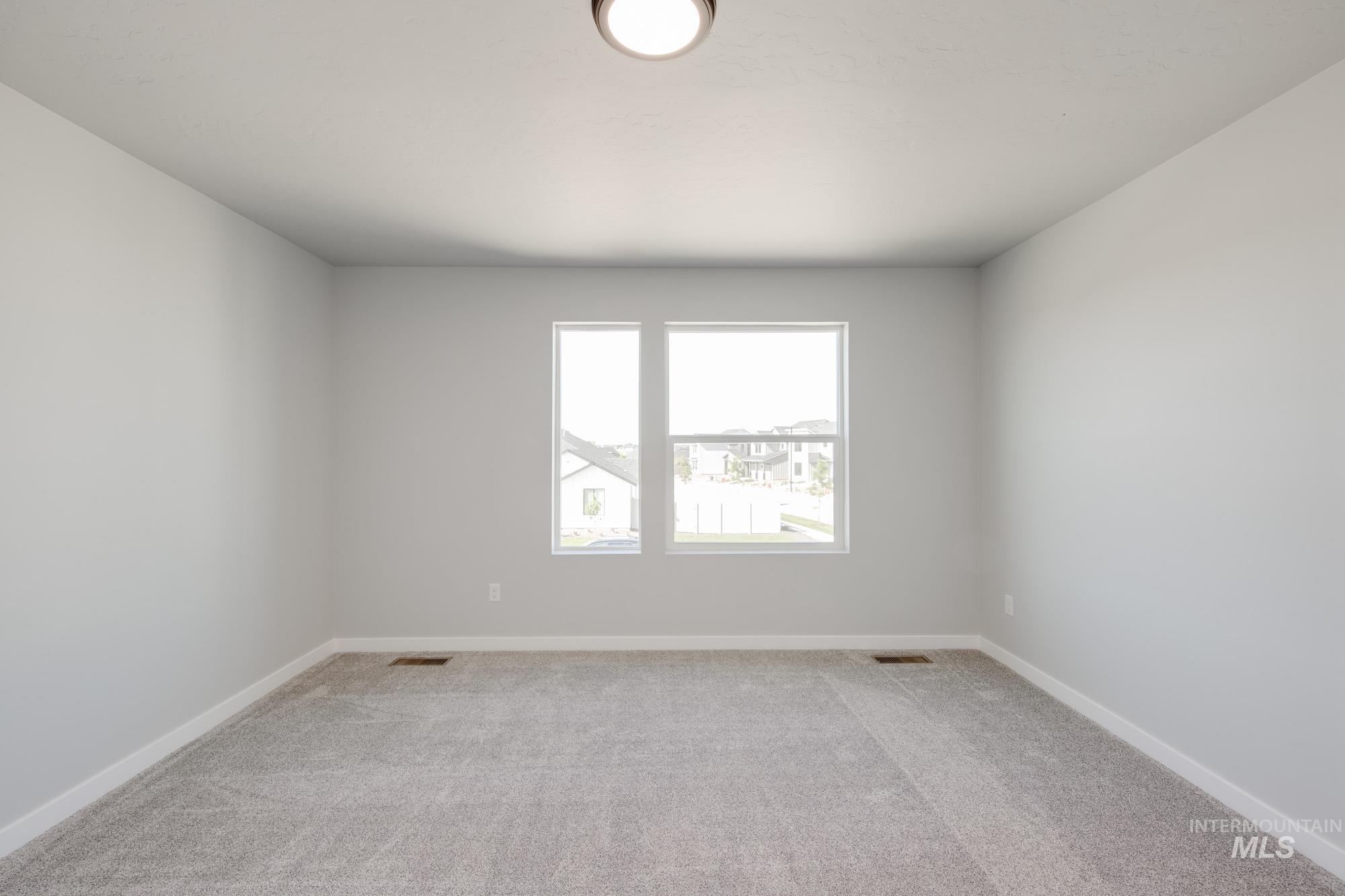 Unfurnished room featuring light colored carpet
