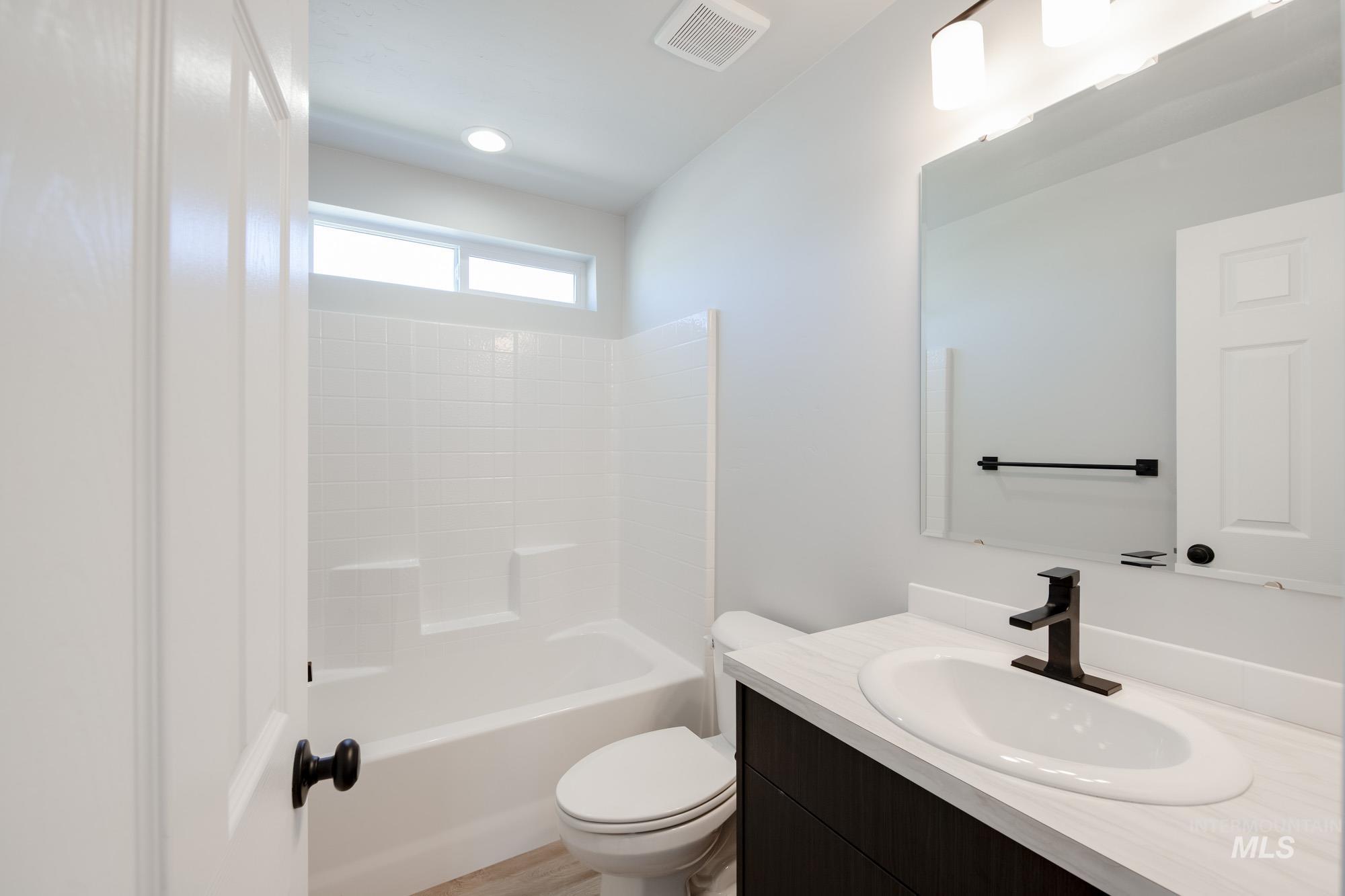 Full bathroom with vanity and tub / shower combination