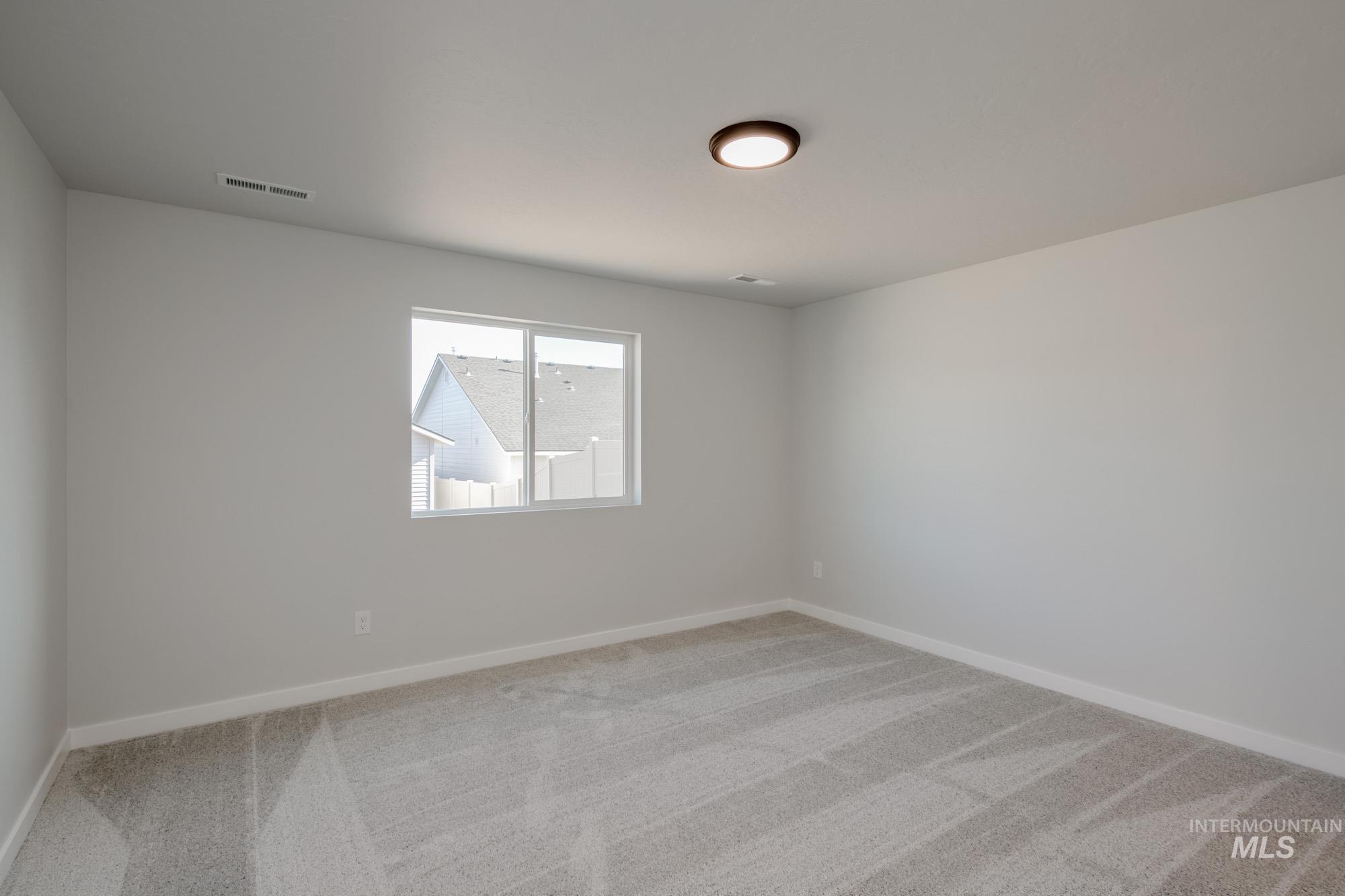 Unfurnished room with light carpet and baseboards