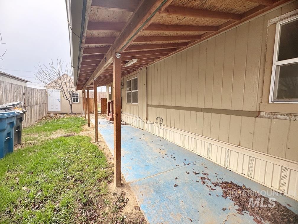 View of side of home featuring a patio area