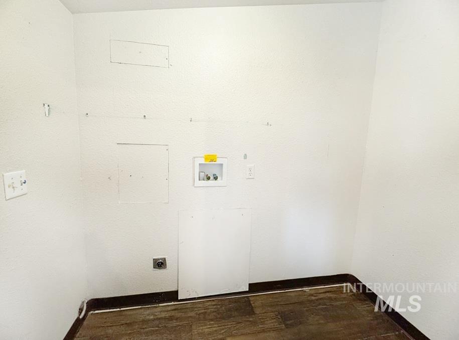 Laundry area with dark wood-type flooring, electric dryer hookup, and hookup for a washing machine