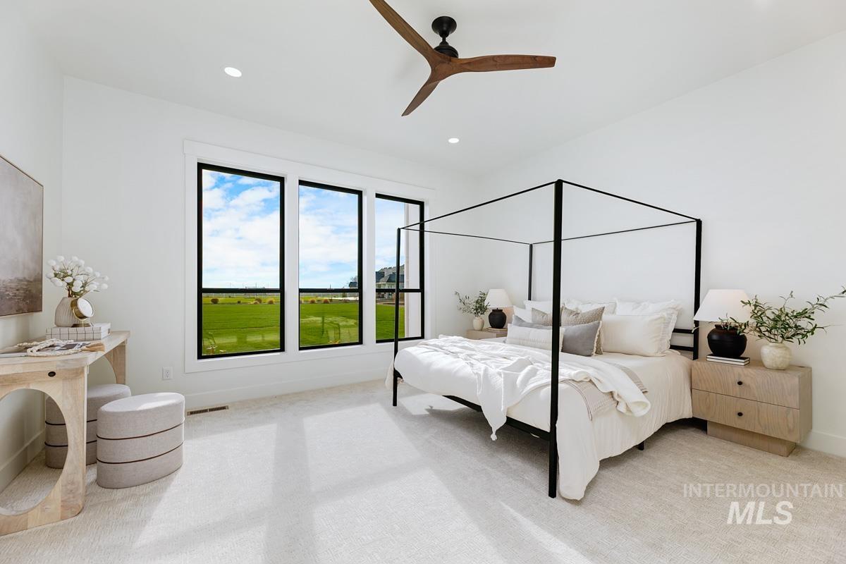 Bedroom with ceiling fan, light carpet, and recessed lighting
