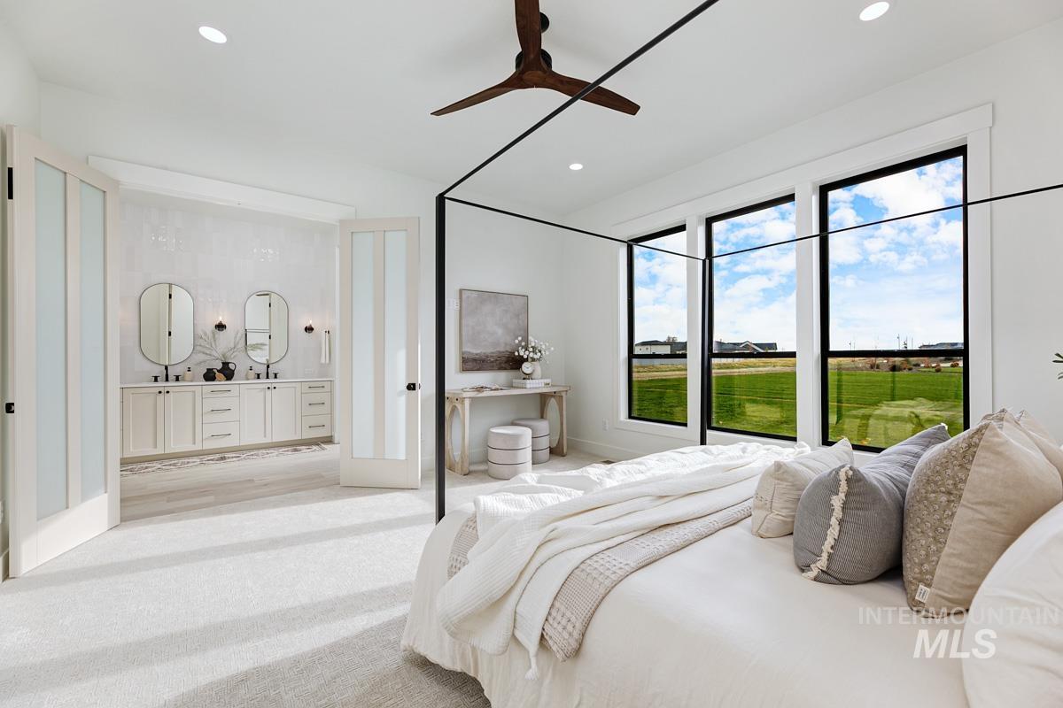 Carpeted bedroom featuring ceiling fan and recessed lighting