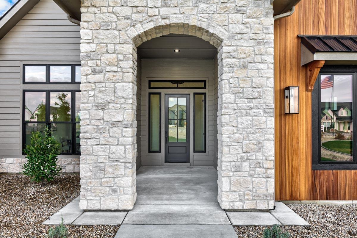 Property entrance featuring stone siding