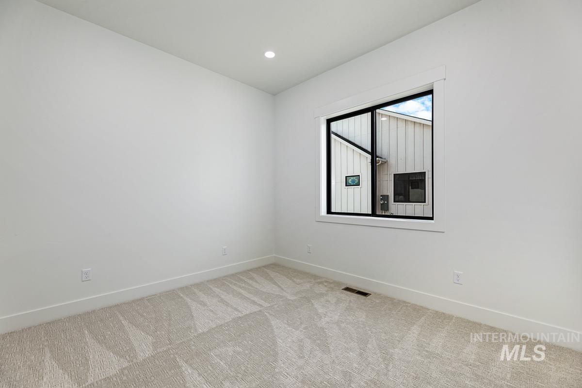 Unfurnished room featuring light colored carpet and recessed lighting