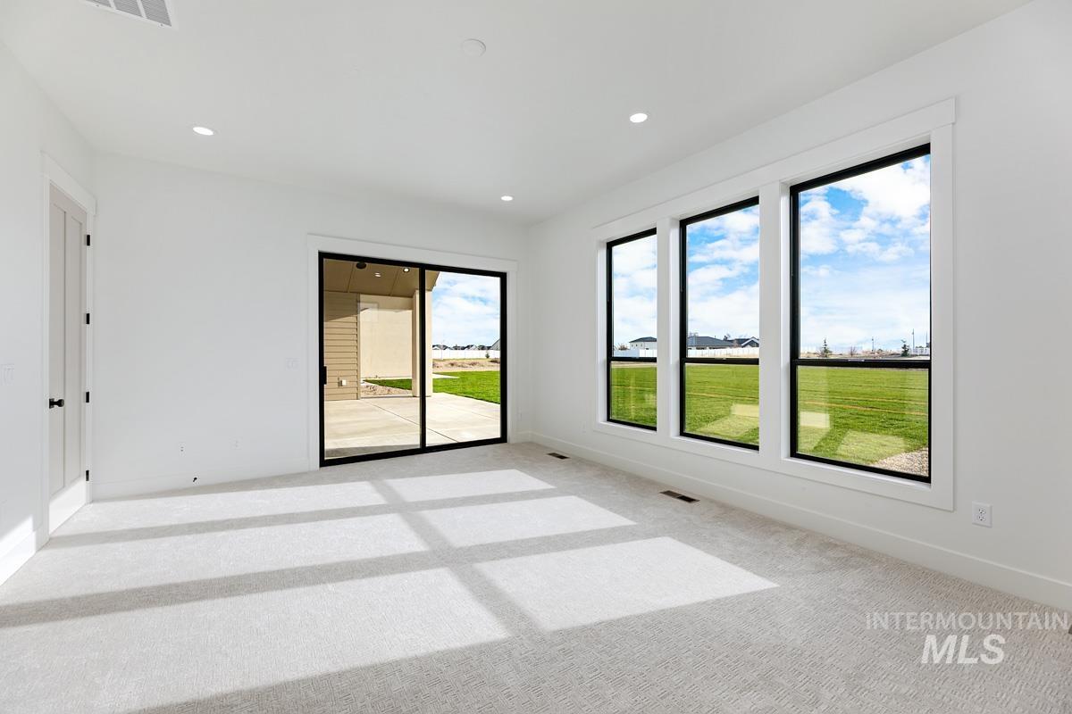 Carpeted spare room featuring recessed lighting and baseboards