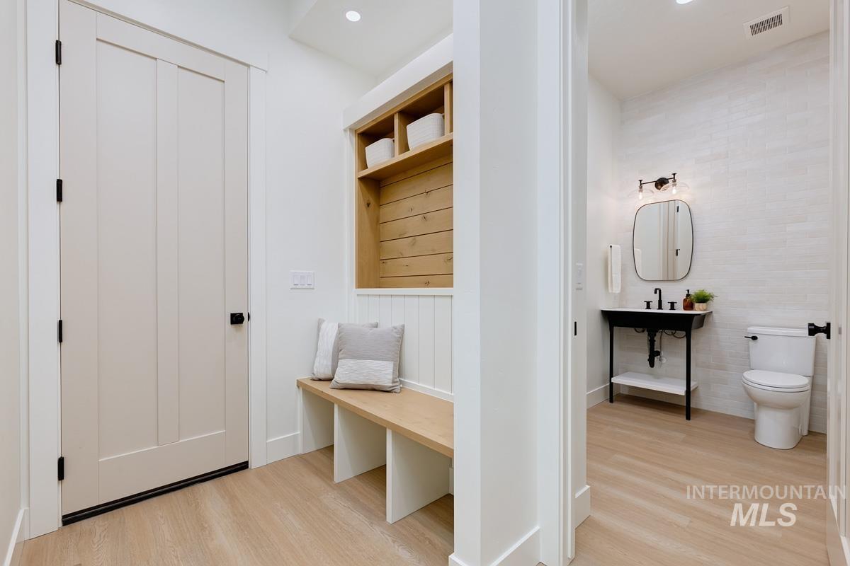 Mudroom with light wood-style floors and recessed lighting