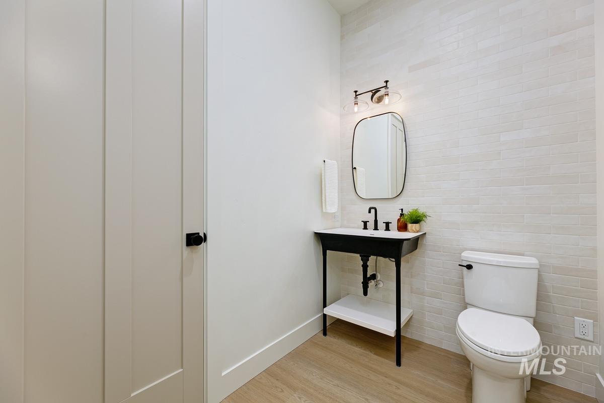 Bathroom with light wood-style flooring and toilet