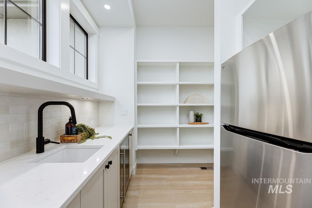 Pantry featuring a sink and wine cooler