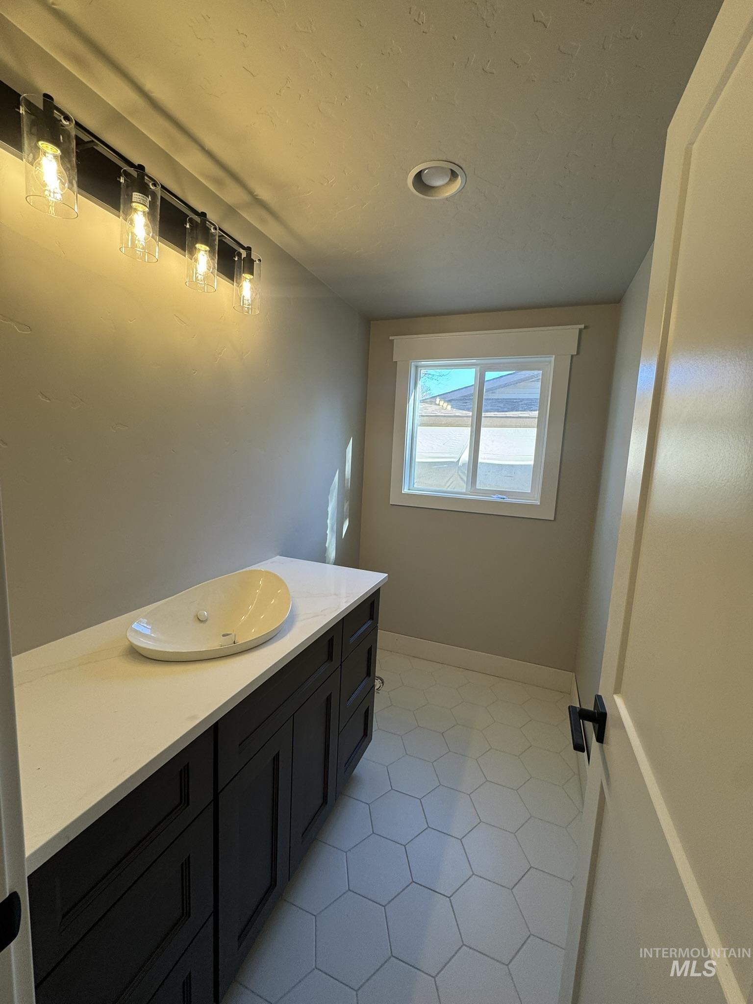 Bathroom with vanity and light tile patterned floors