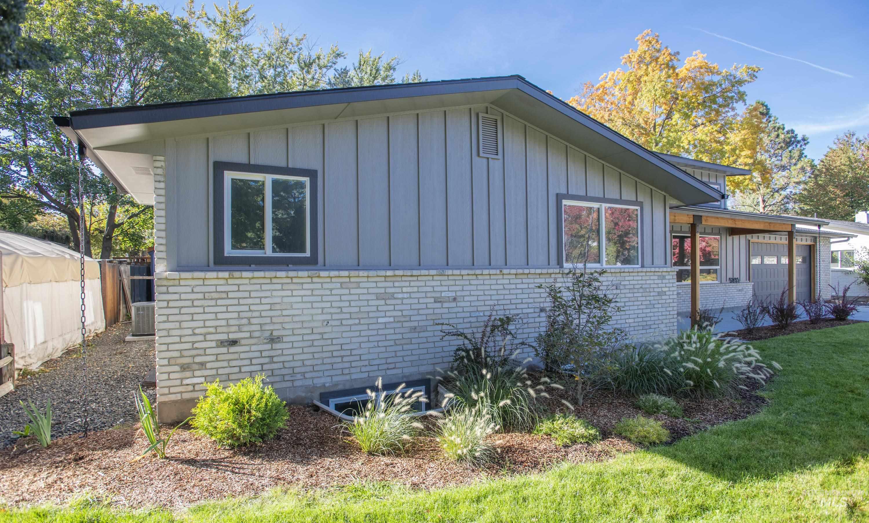 View of property exterior with brick siding and board and batten siding