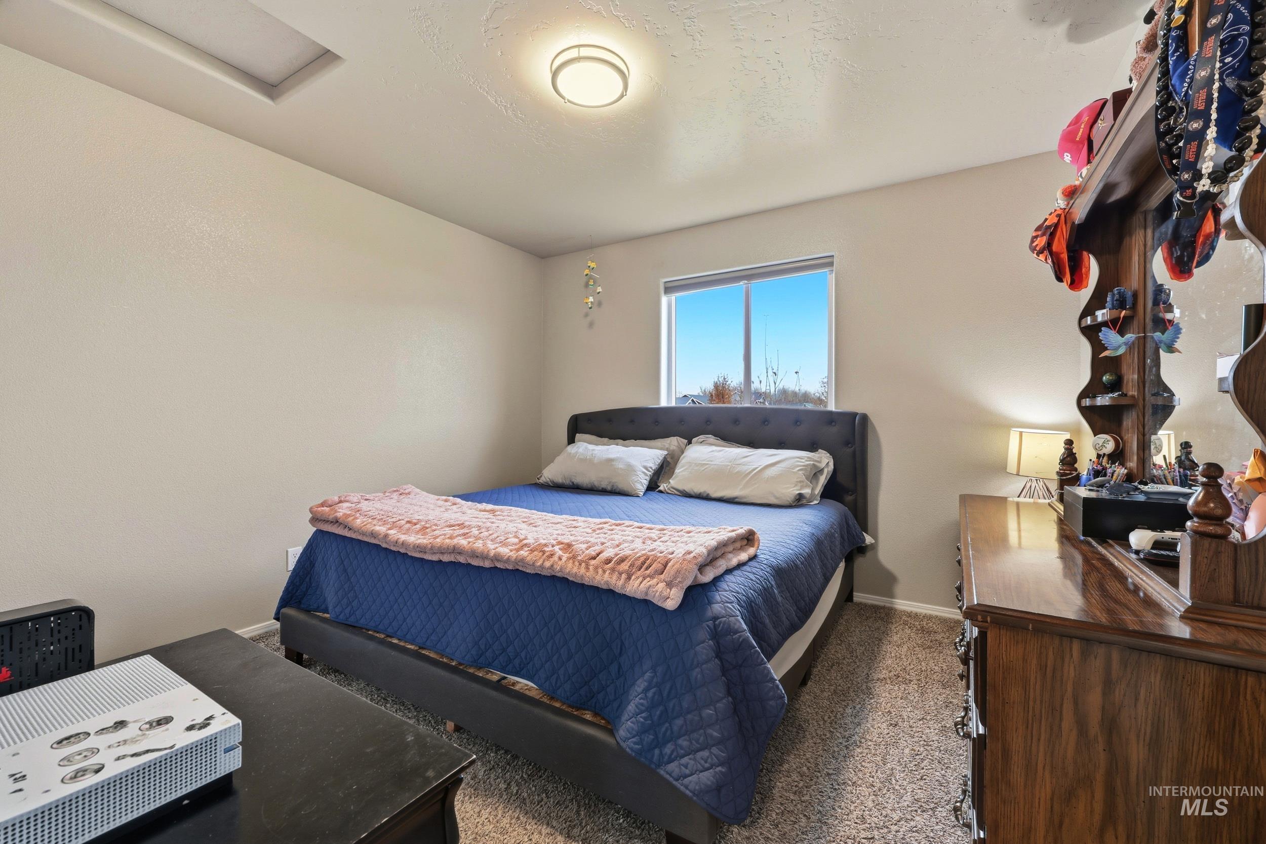 Bedroom with carpet and baseboards