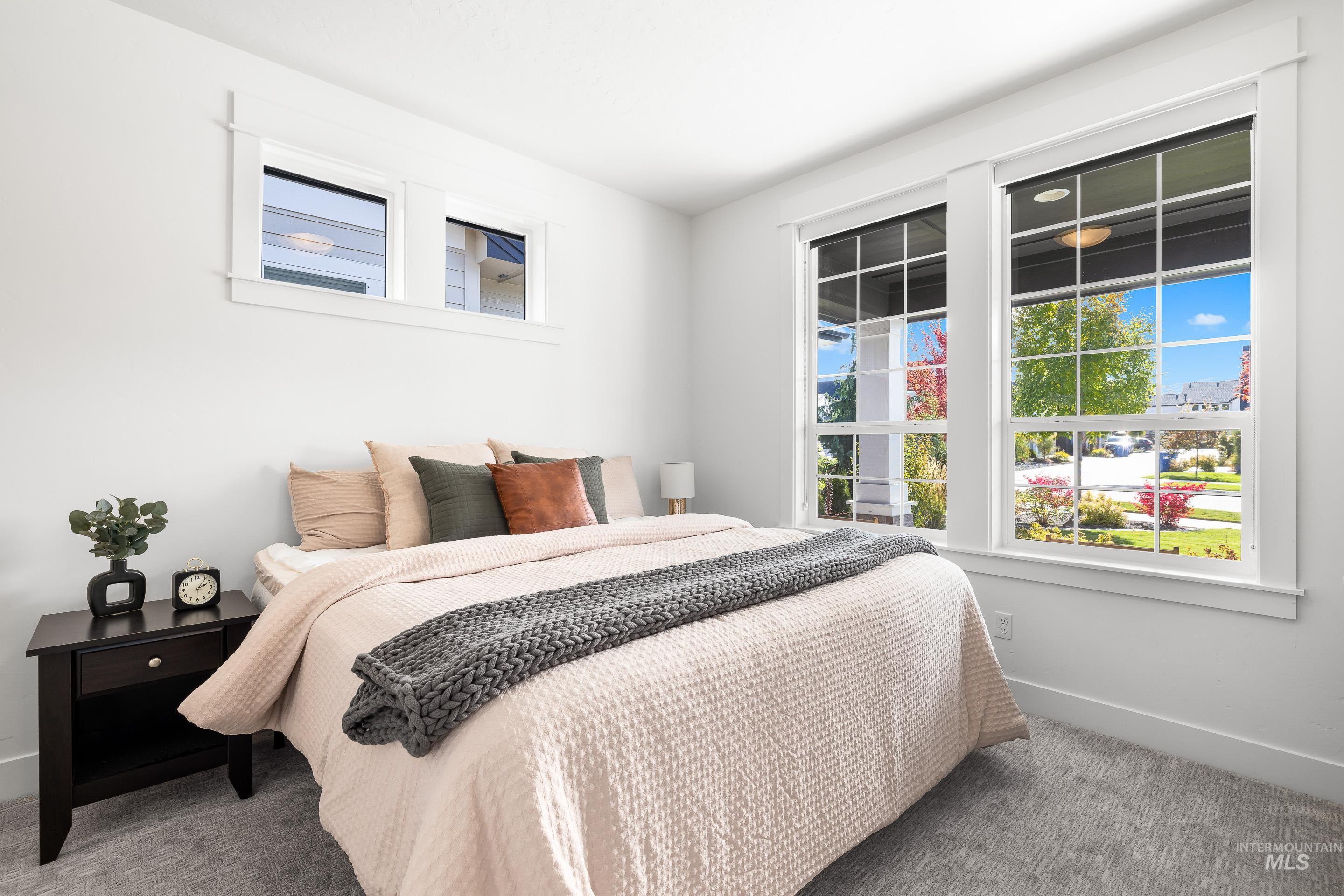 Carpeted bedroom featuring baseboards