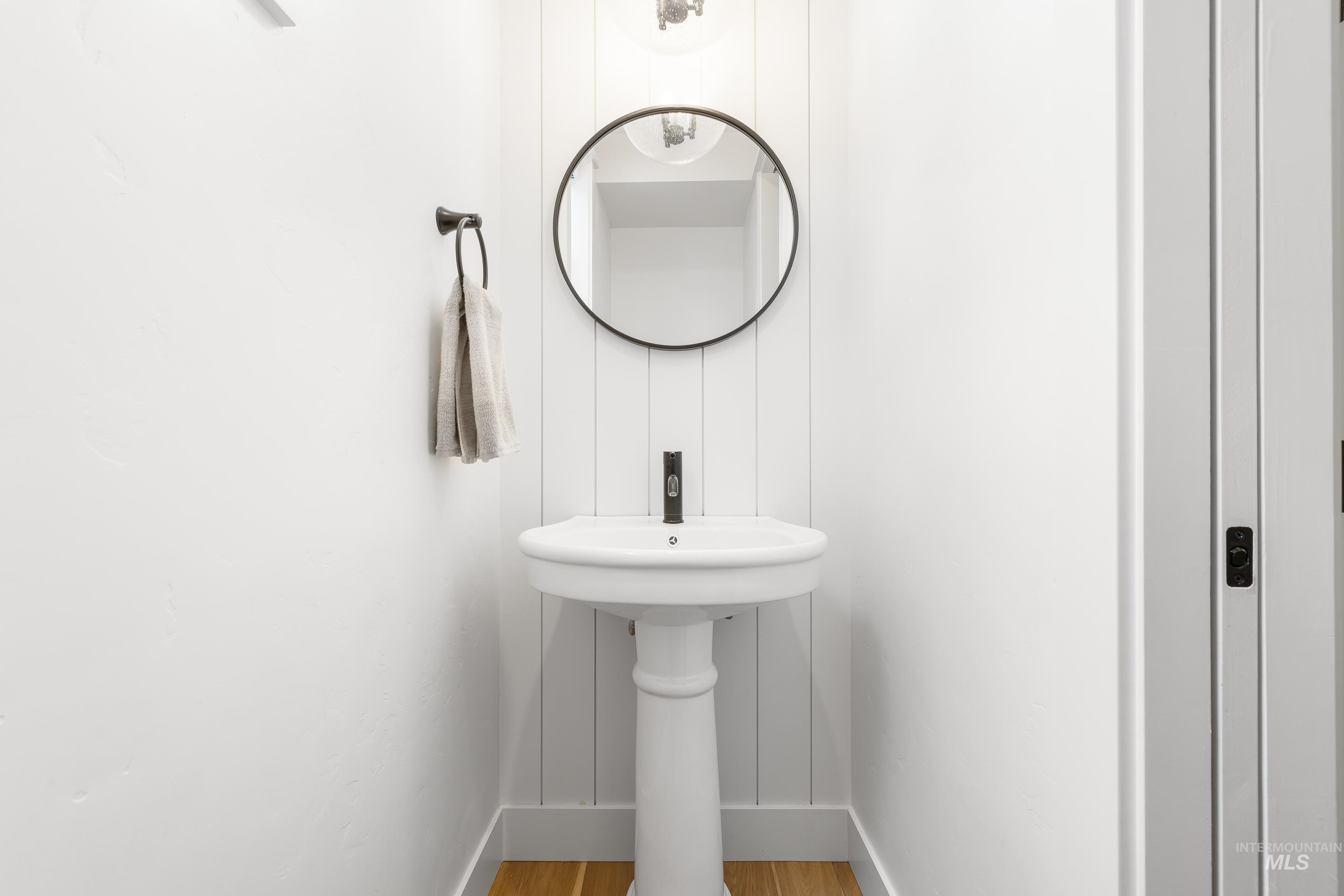 Bathroom with wood finished floors and baseboards