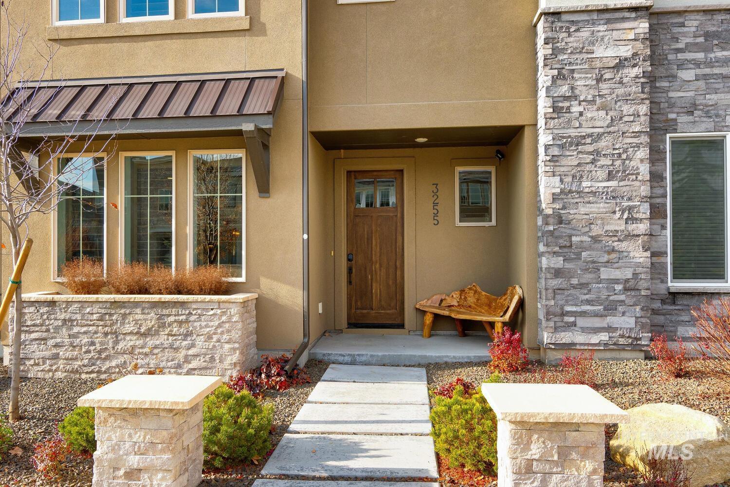 Property entrance with stucco siding and stone siding