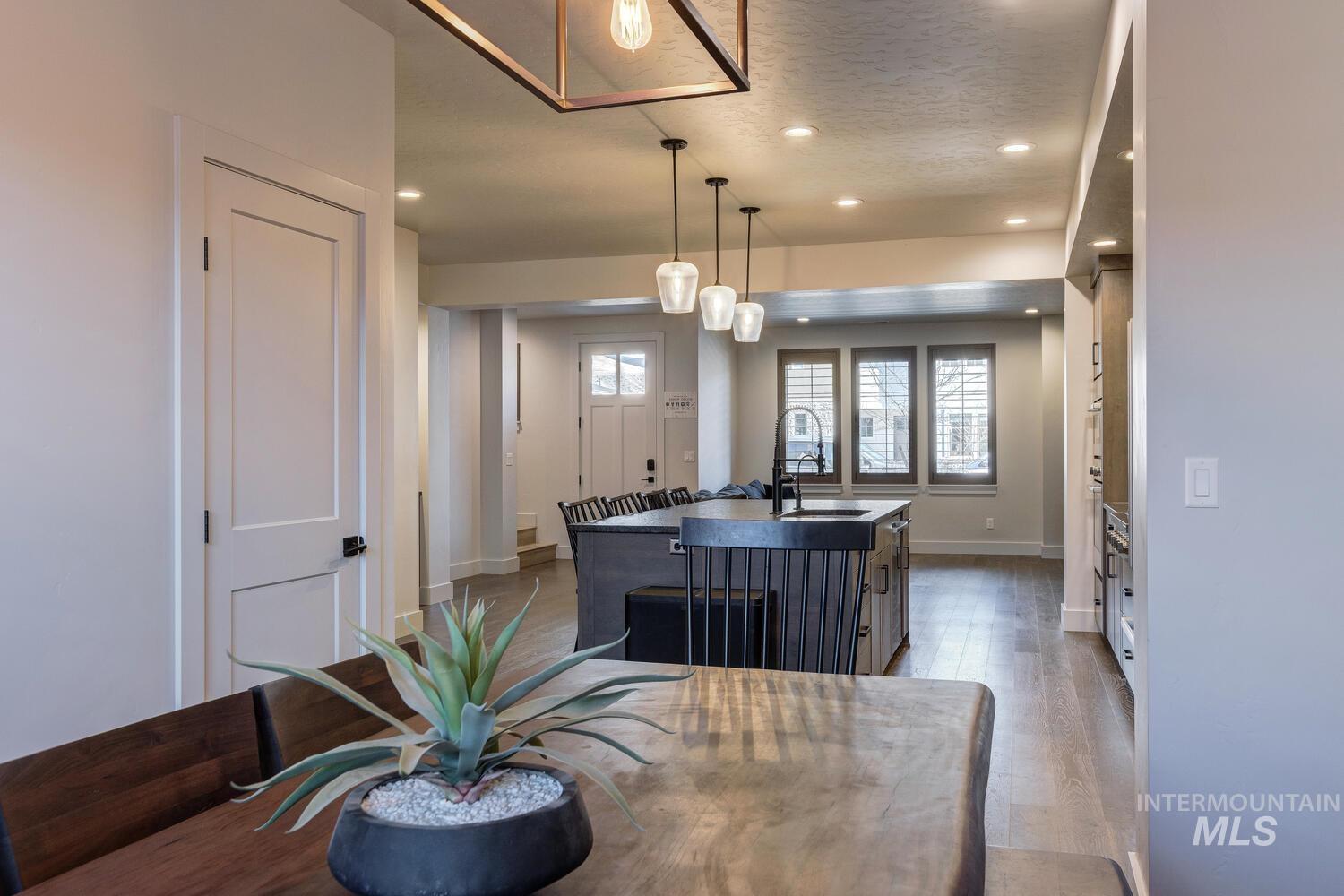 Dining room featuring light wood-style flooring, recessed lighting, and a textured ceiling