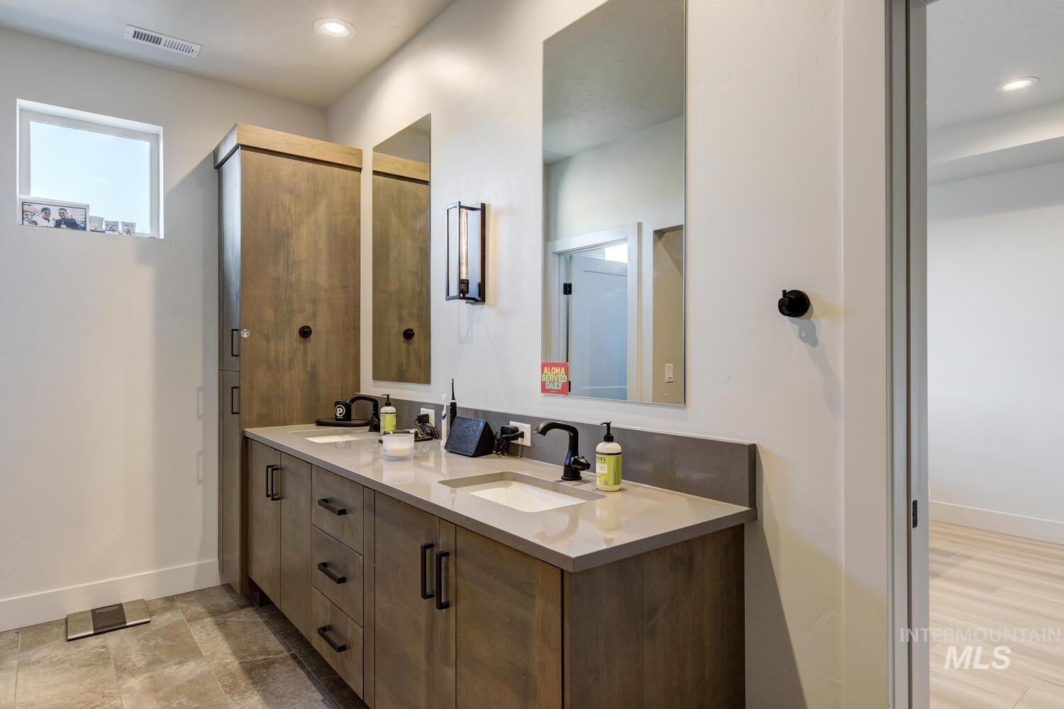 Full bath featuring double vanity and recessed lighting