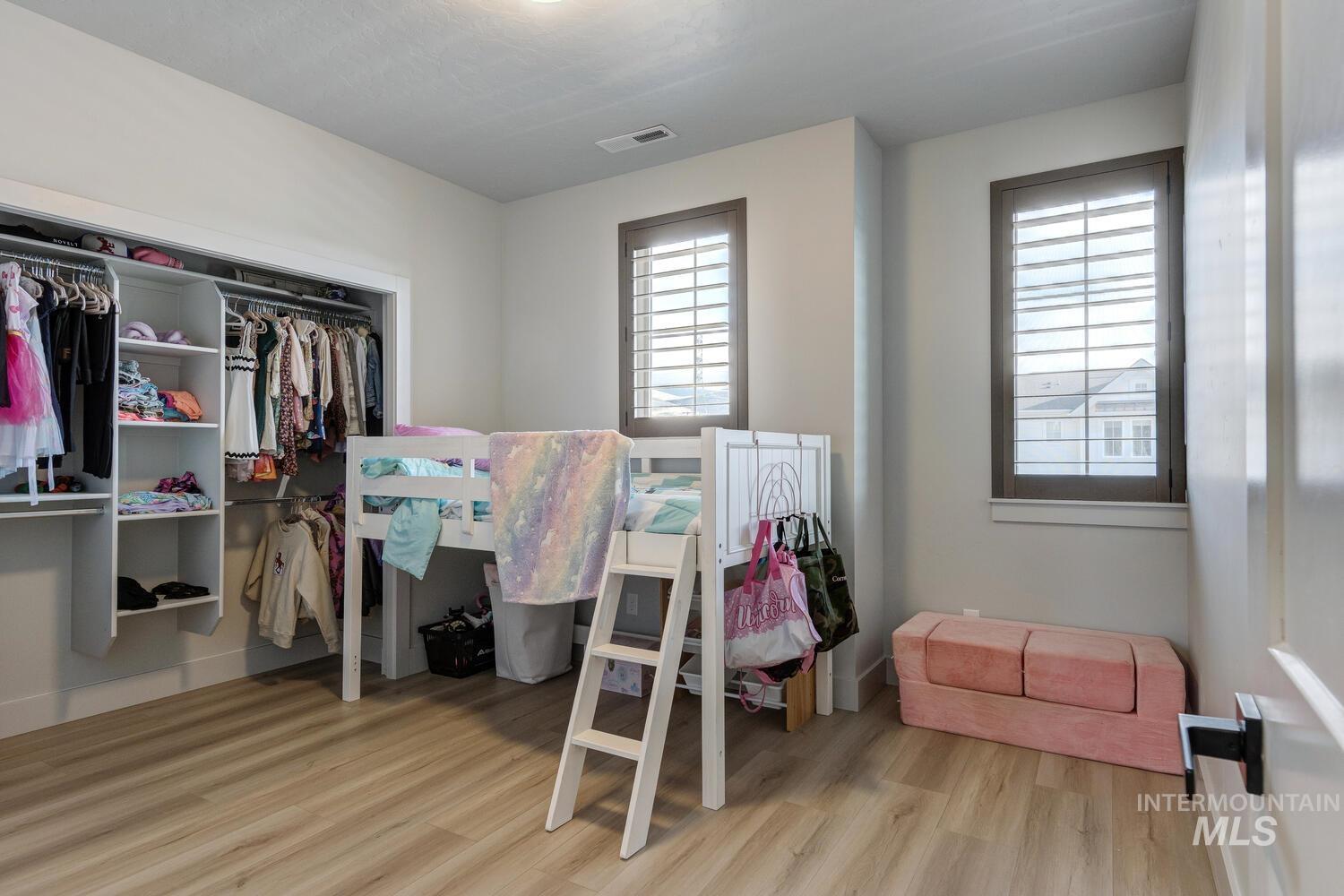 Bedroom with a closet and light wood finished floors