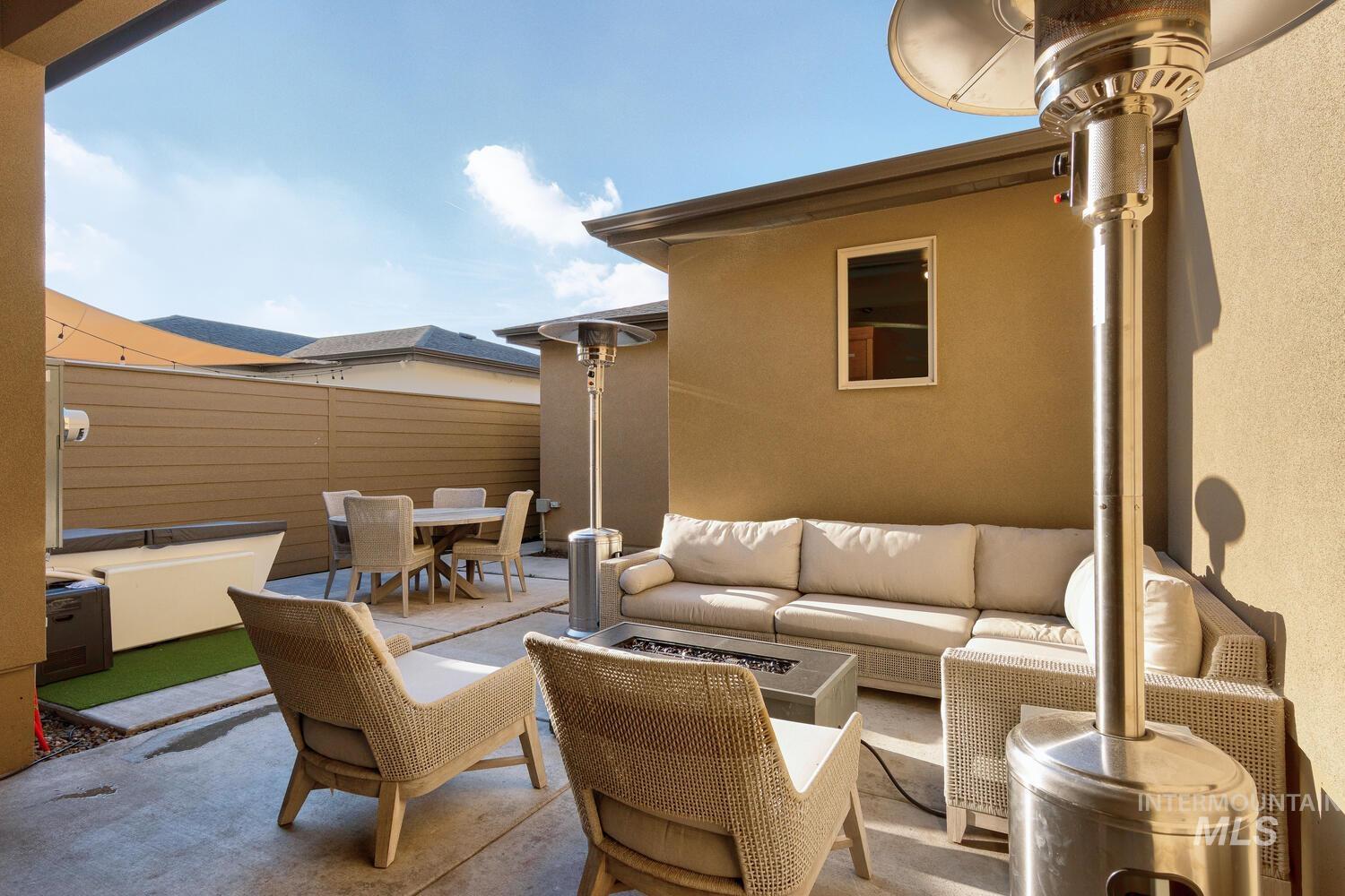 View of patio with outdoor dining space, a jacuzzi, and outdoor lounge area