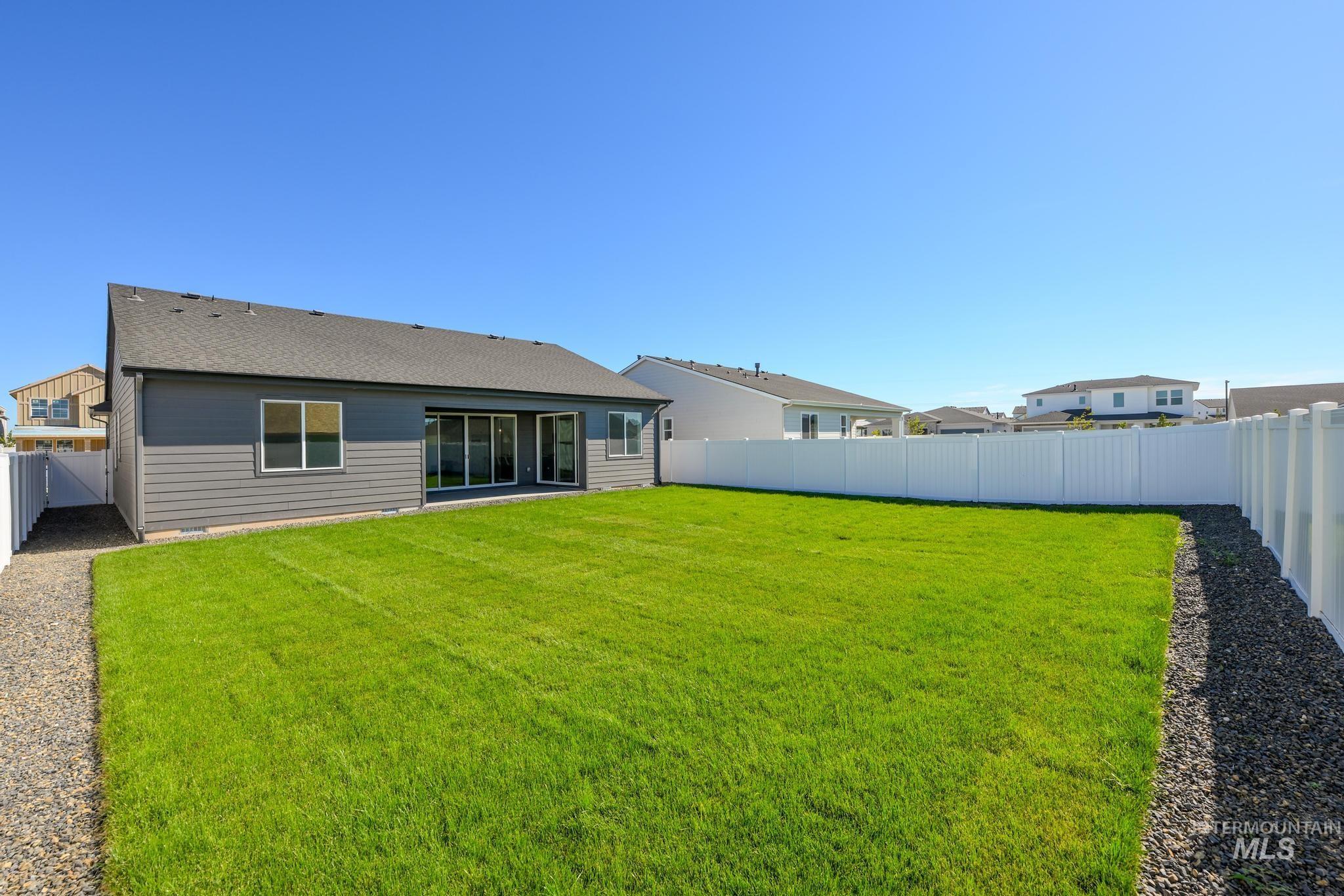 Rear view of property with a fenced backyard and a shingled roof