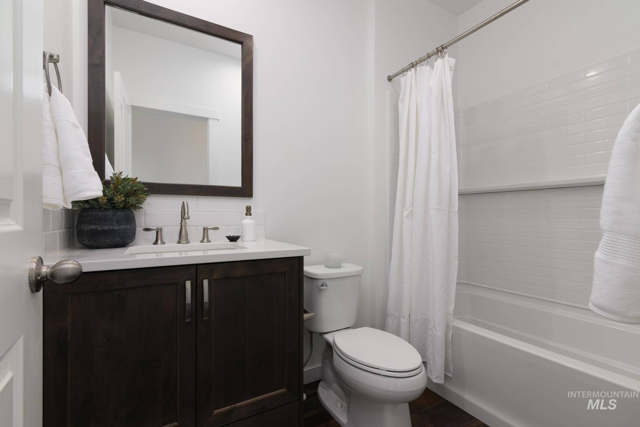Bathroom featuring vanity and shower / bath combo