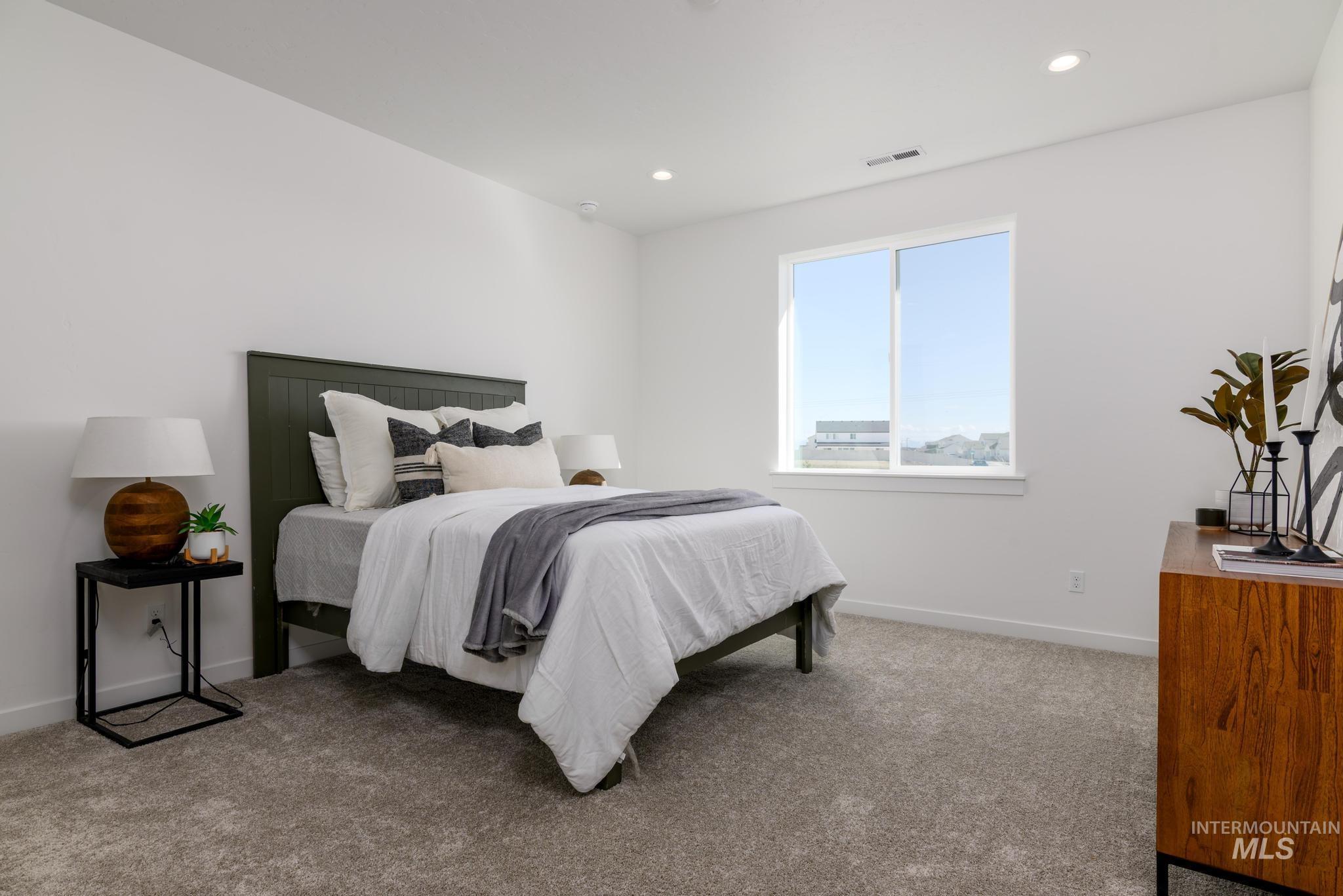 Bedroom featuring light colored carpet and recessed lighting