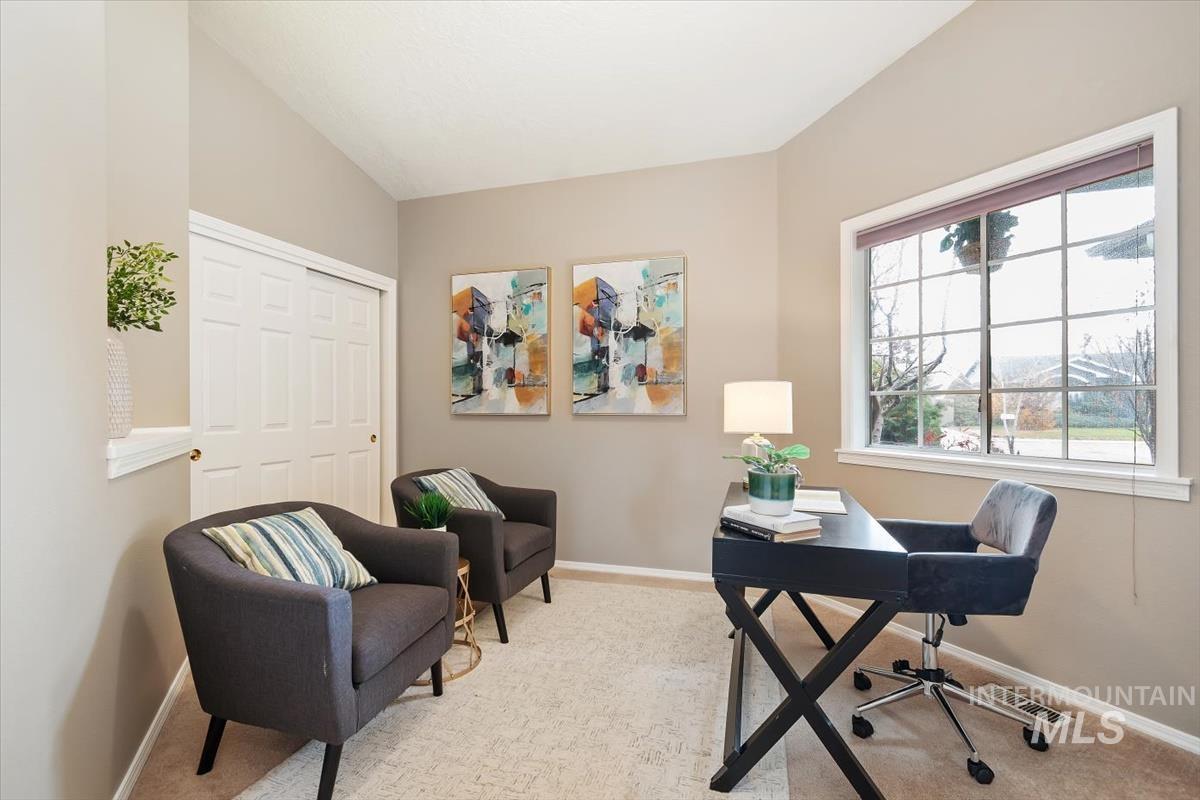 Office with lofted ceiling and carpet