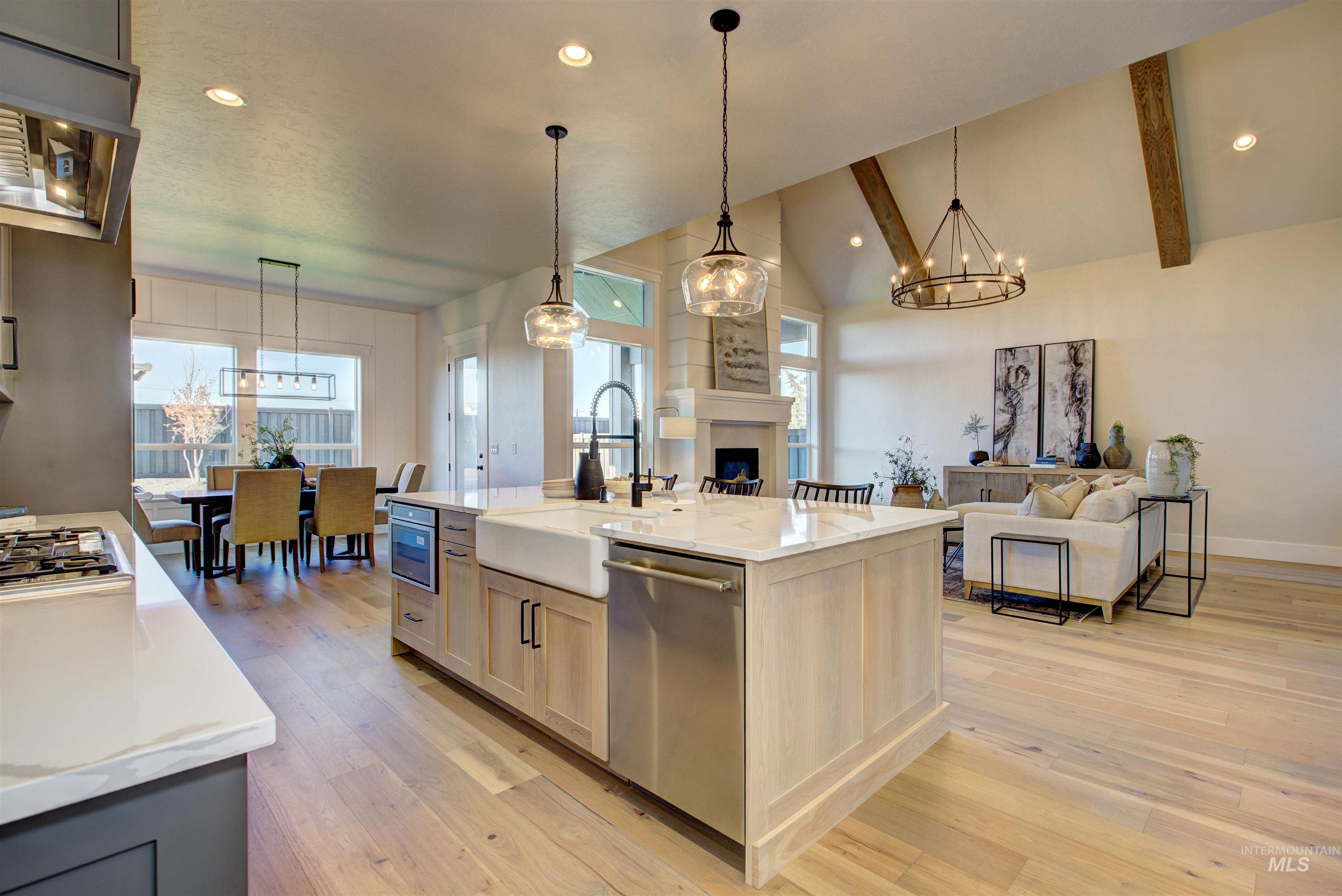 Kitchen featuring recessed lighting, ventilation hood, hanging light fixtures, light wood-style floors, and stainless steel appliances