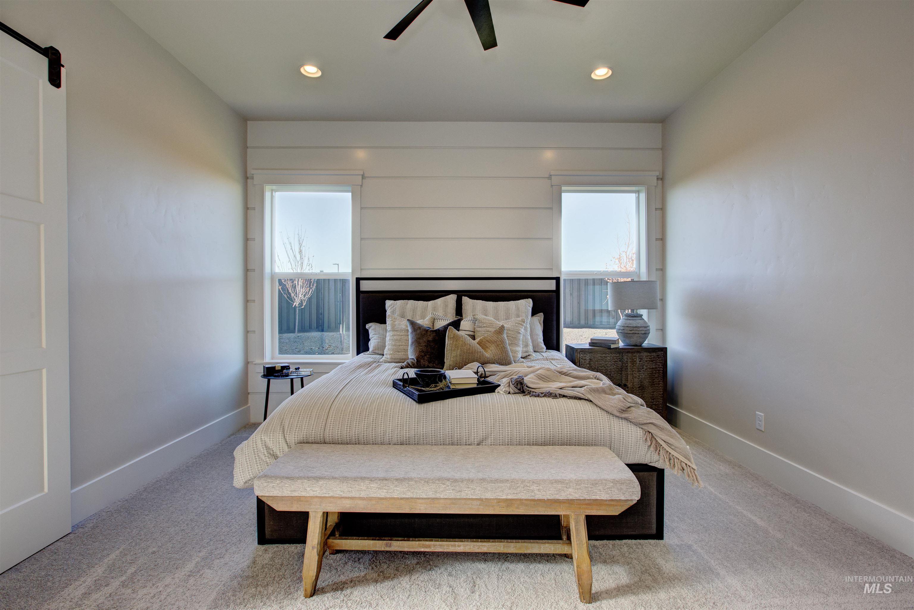 Carpeted bedroom with recessed lighting and ceiling fan