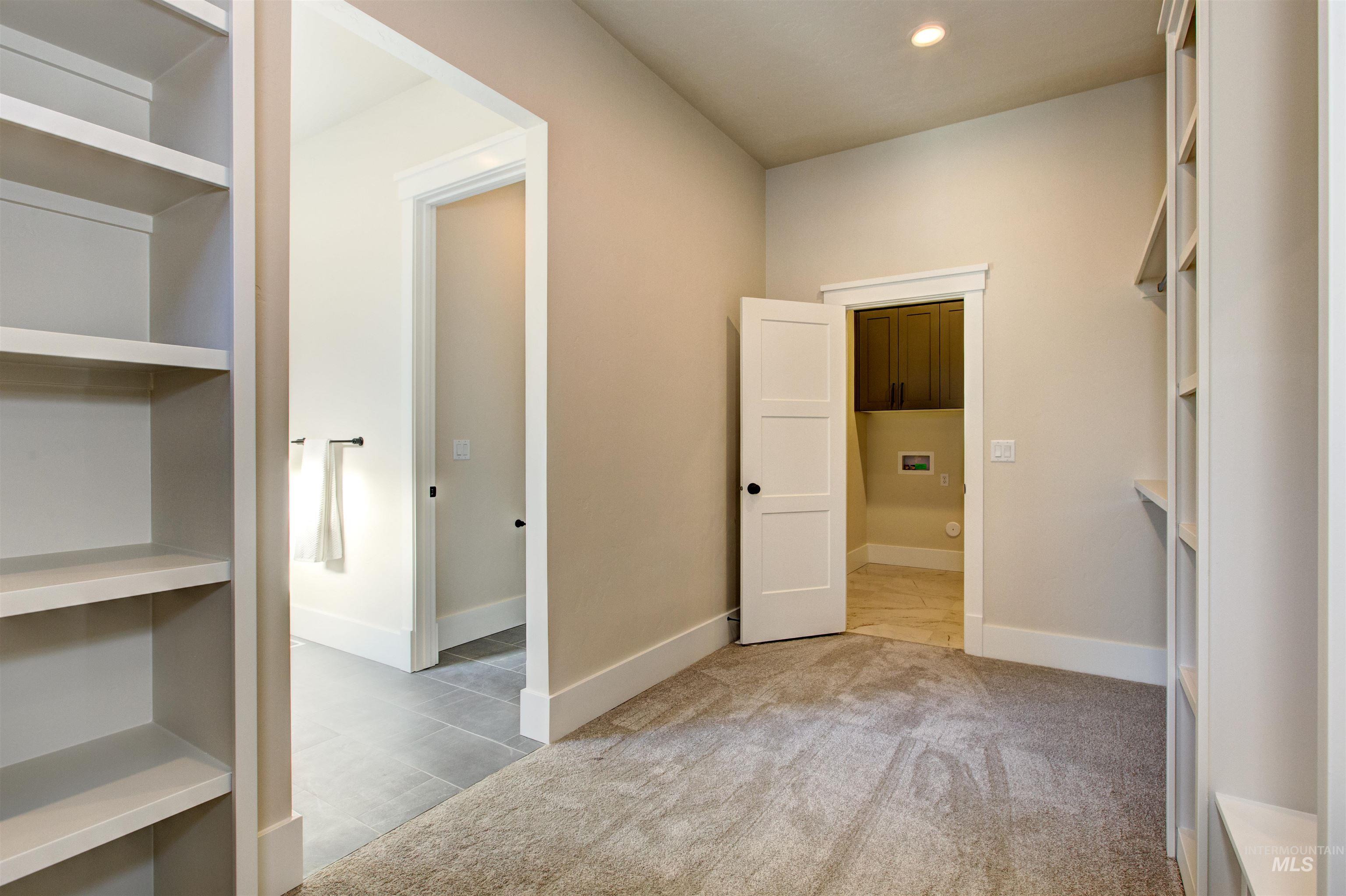 Empty room with light tile patterned floors, light colored carpet, and recessed lighting