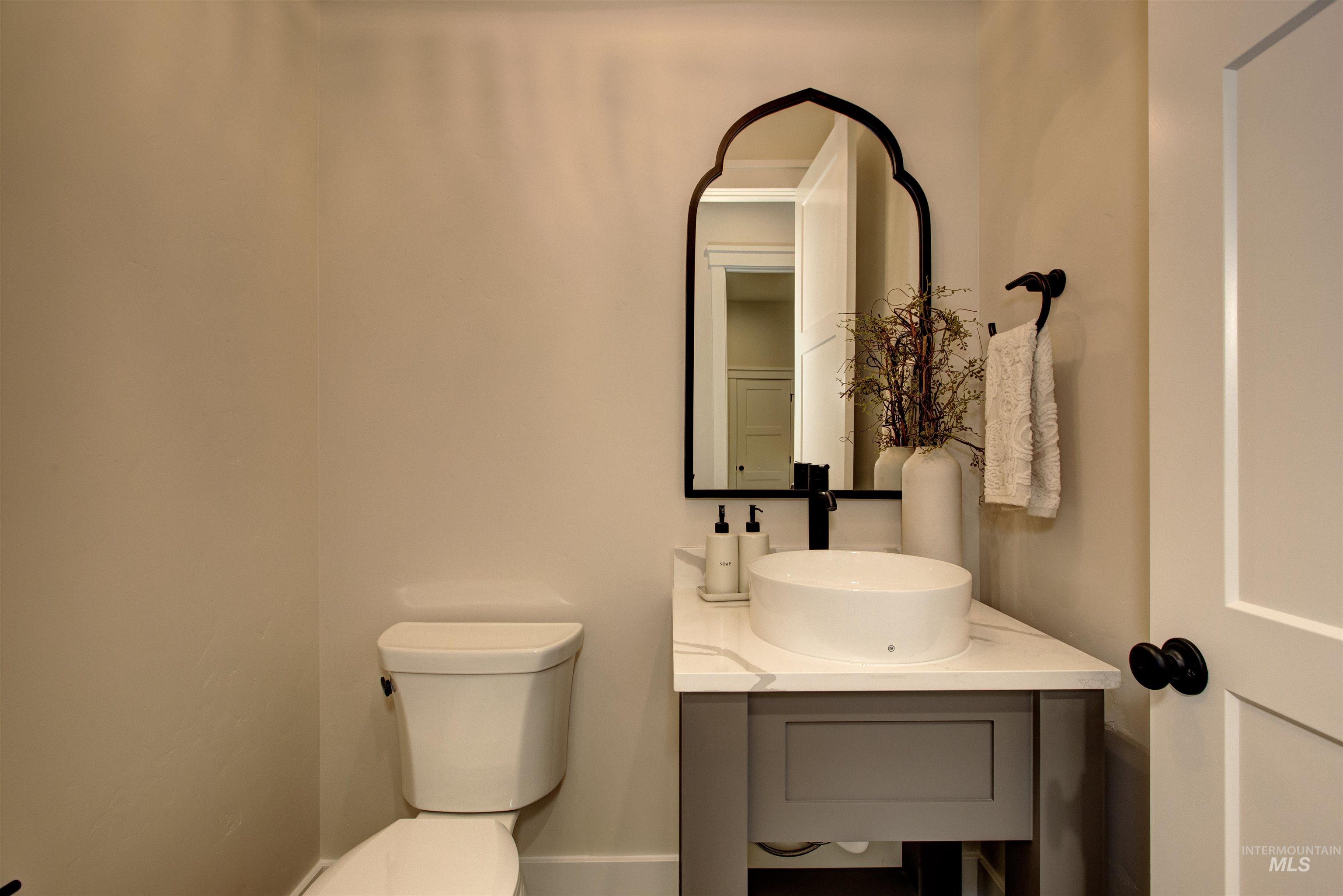 Half bath featuring vanity and toilet