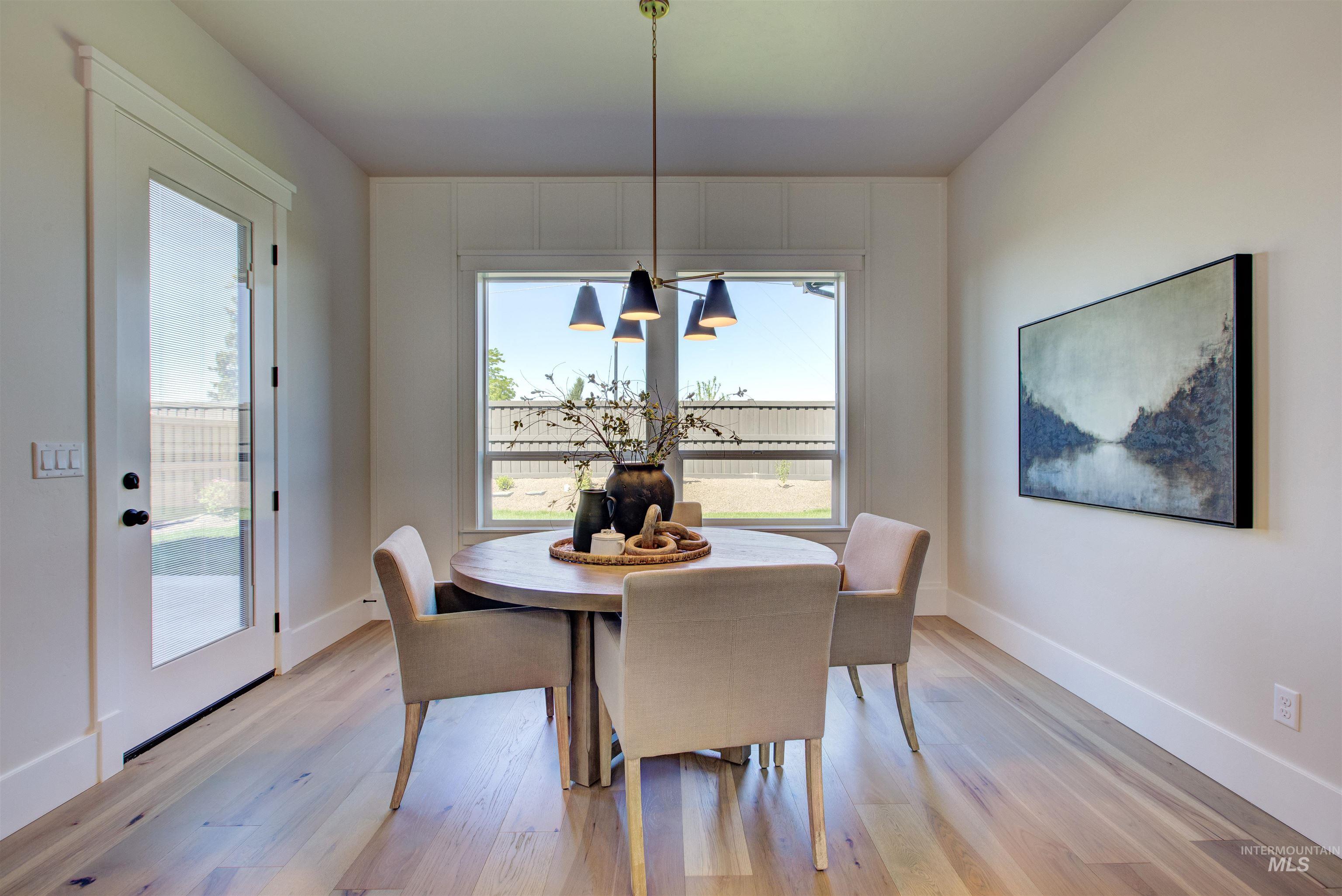 Dining room featuring light wood-type flooring and baseboards