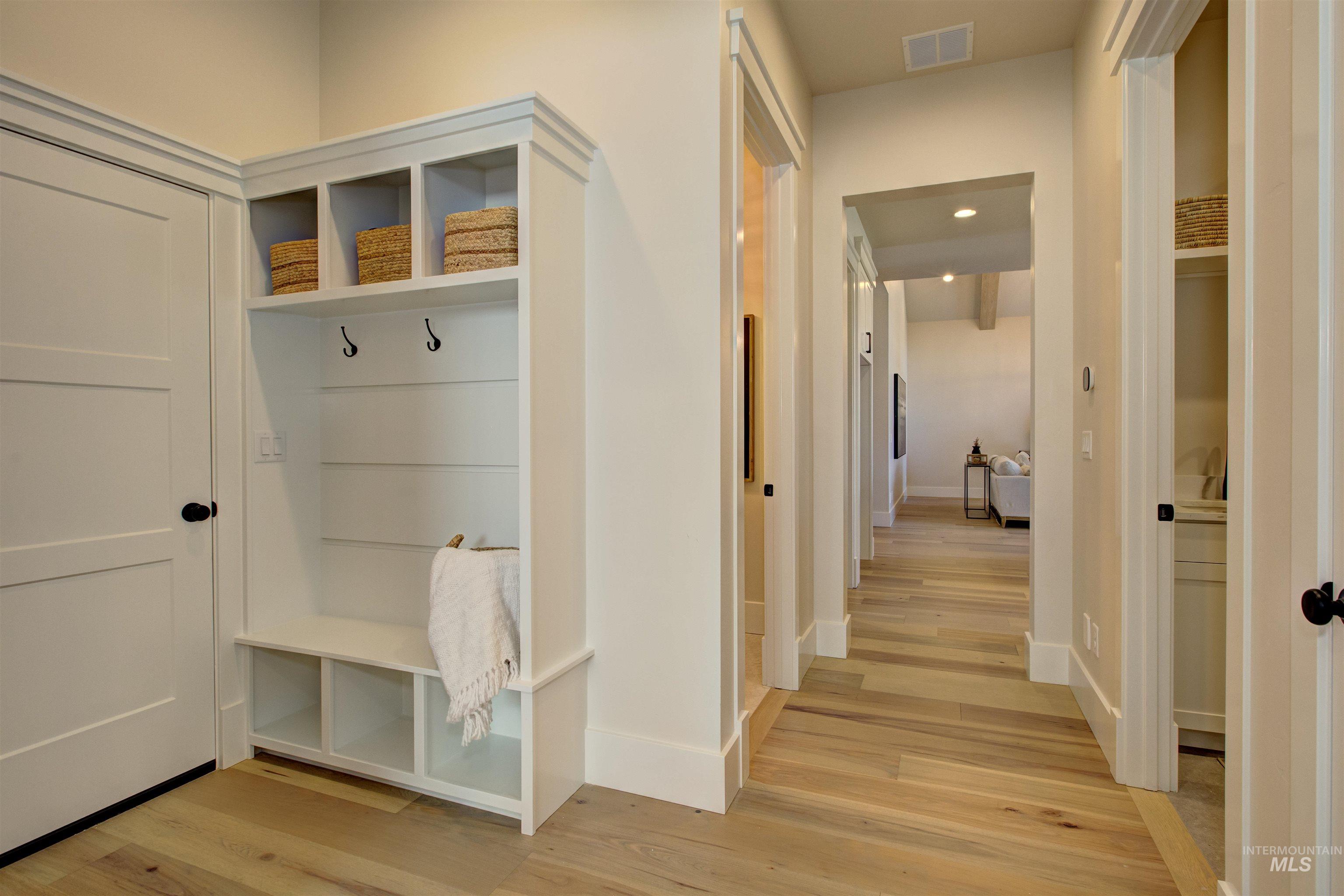 Mudroom featuring light wood-type flooring and recessed lighting