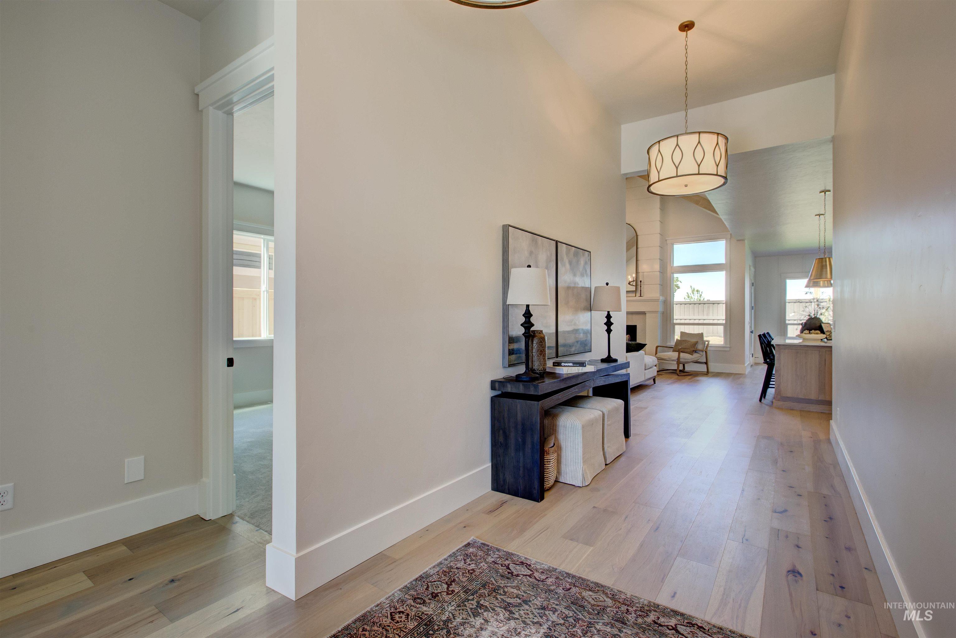 Corridor featuring light wood finished floors