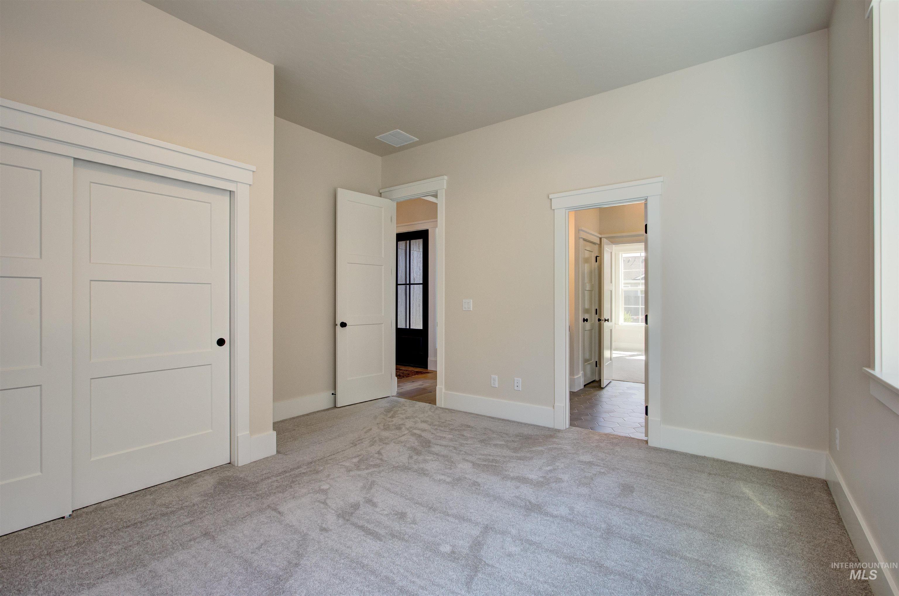 Unfurnished bedroom featuring carpet floors, a closet, and connected bathroom