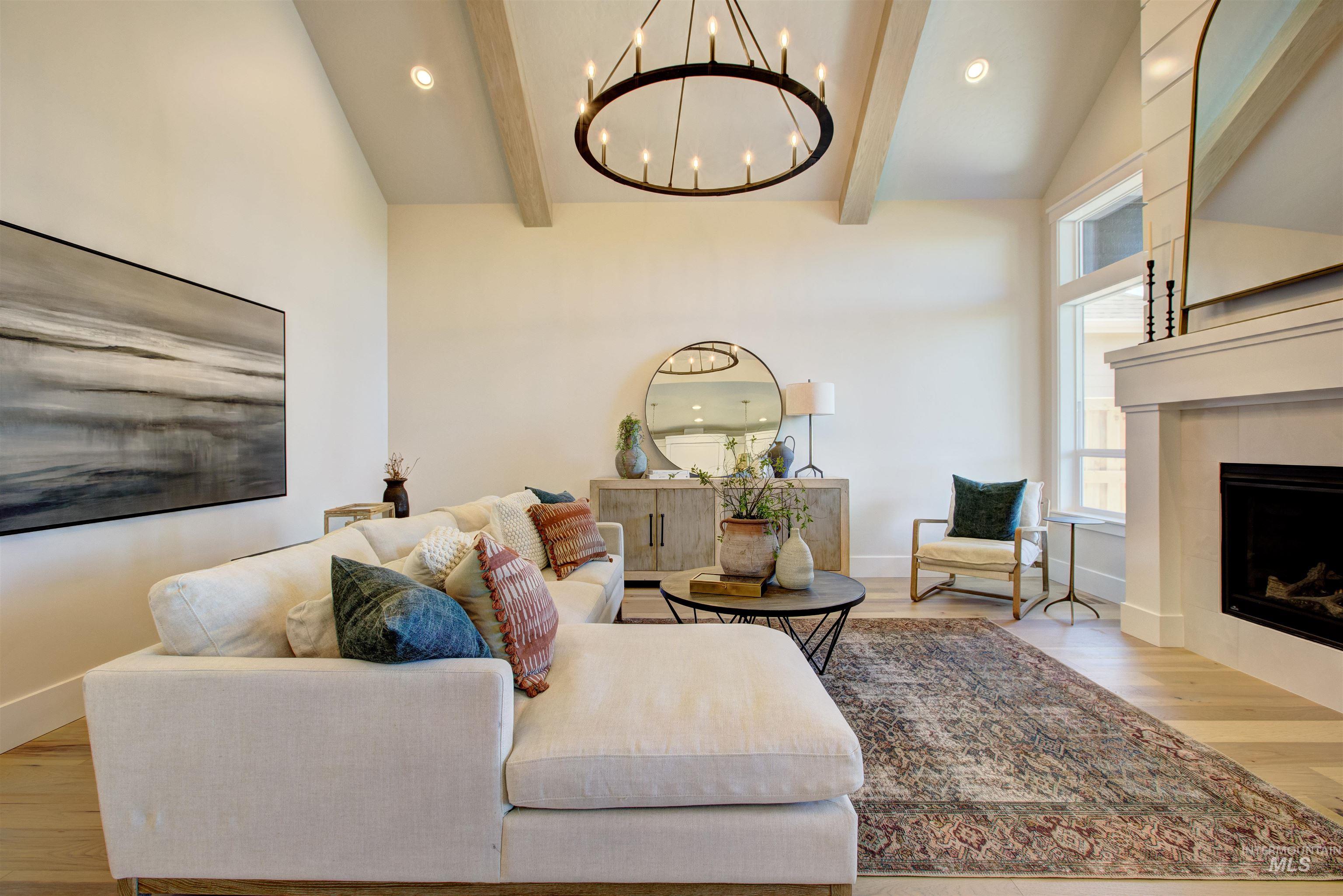 Living room featuring a chandelier, wood finished floors, a fireplace, and recessed lighting