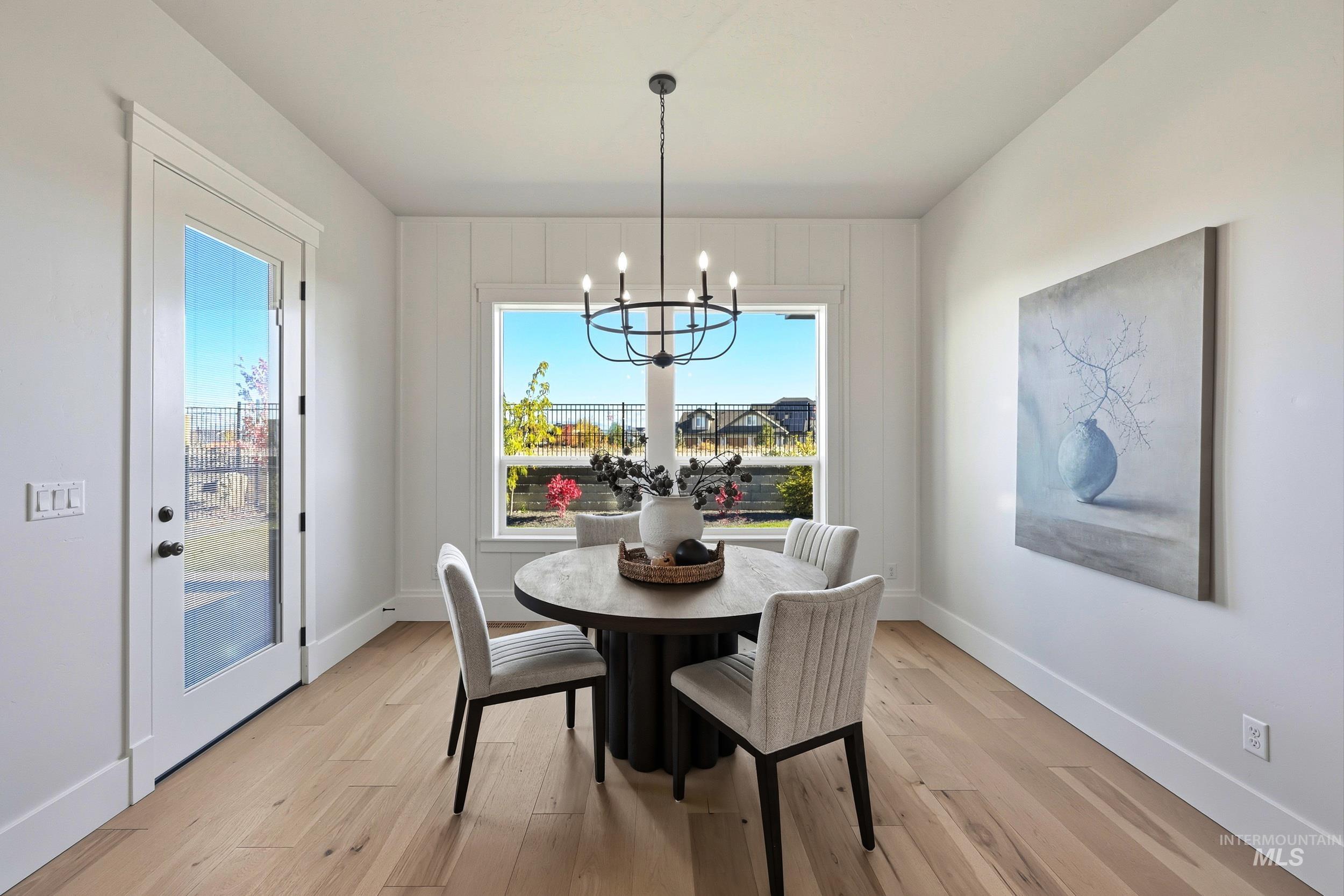 Dining room featuring light wood-type flooring and a chandelier