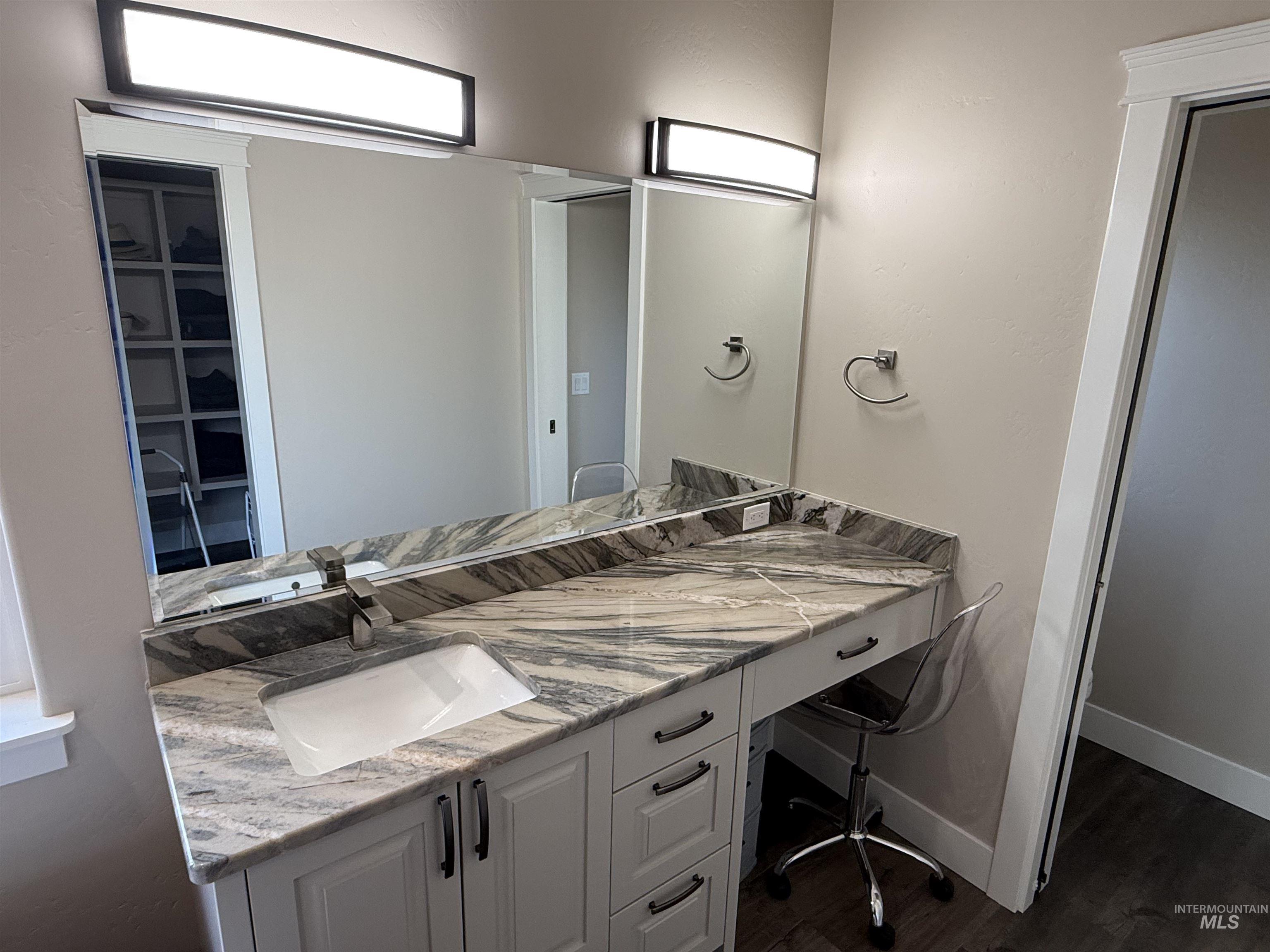 Bathroom with vanity and dark wood-style floors