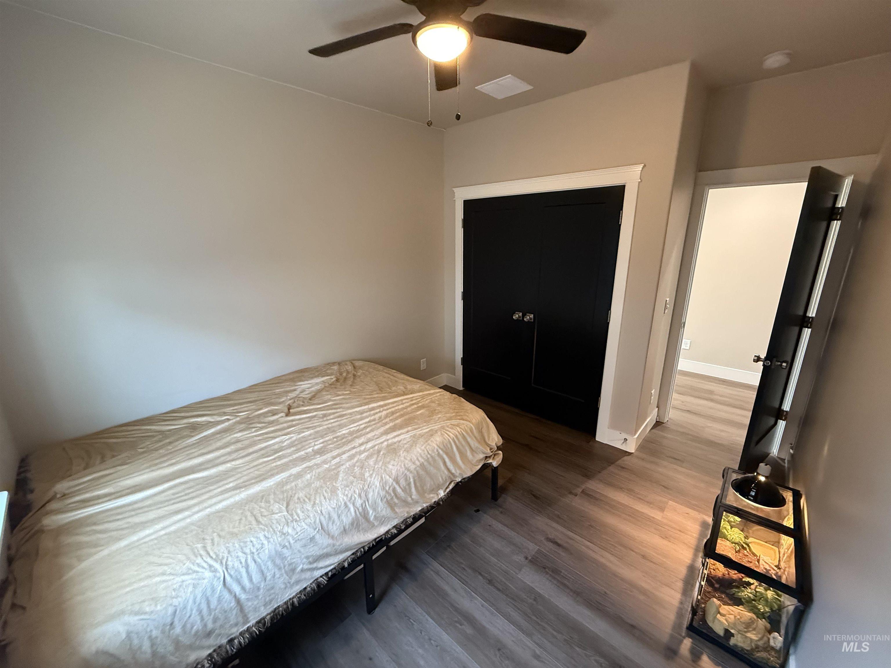 Bedroom featuring a ceiling fan and wood finished floors