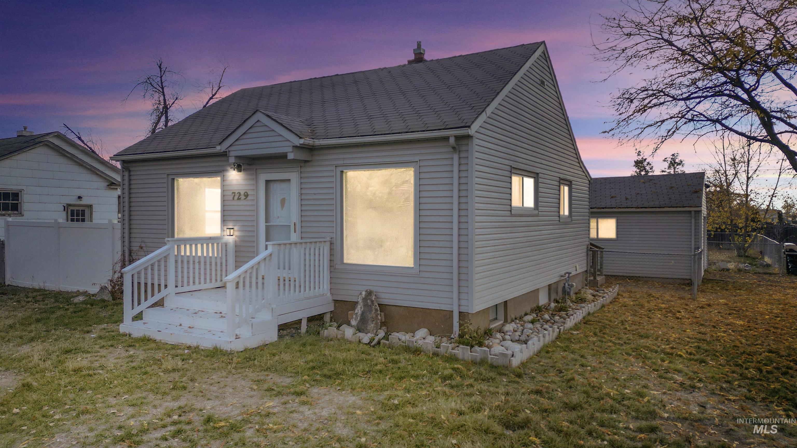 View of front of house featuring a wooden deck
