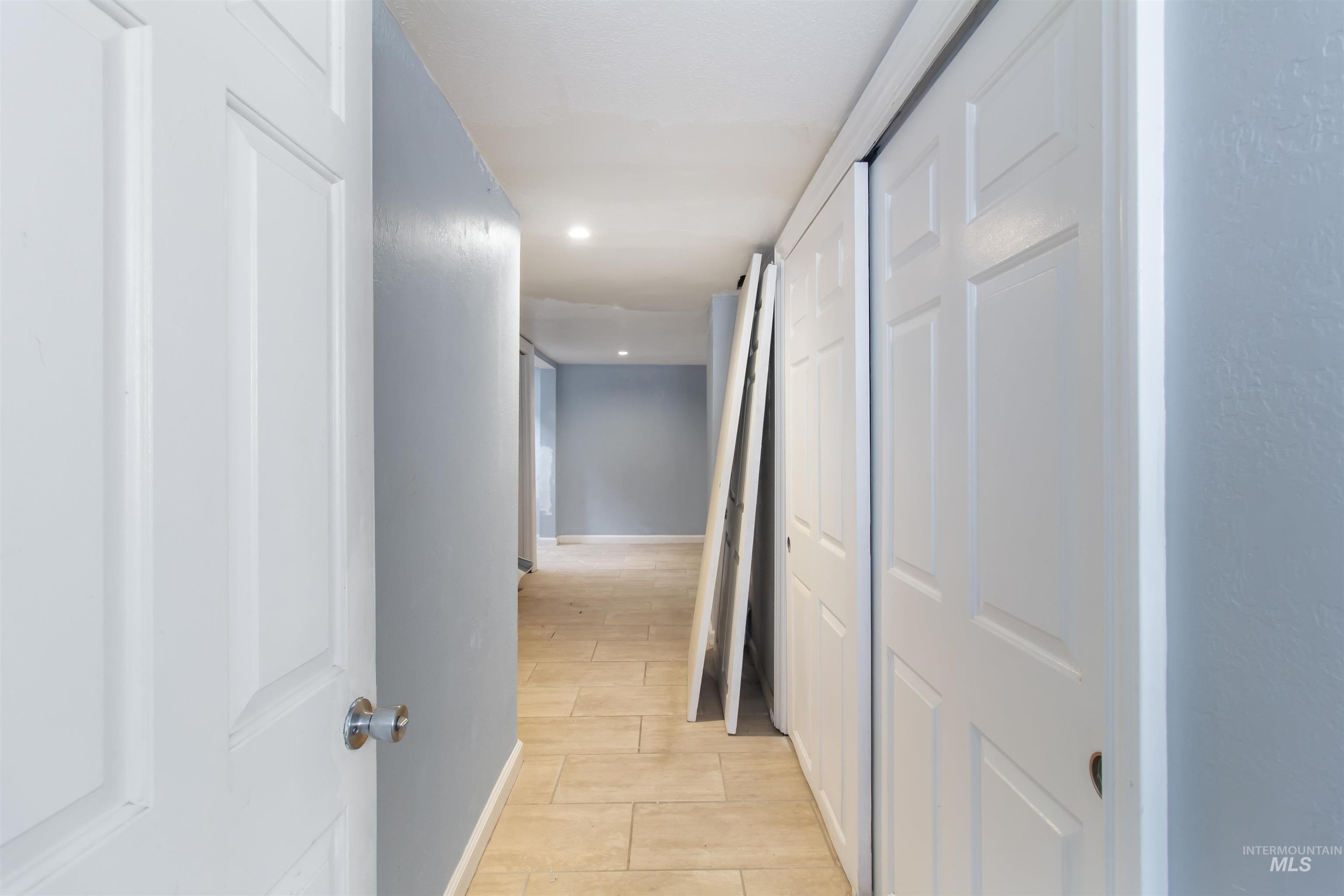 Corridor with recessed lighting and wood finish floors