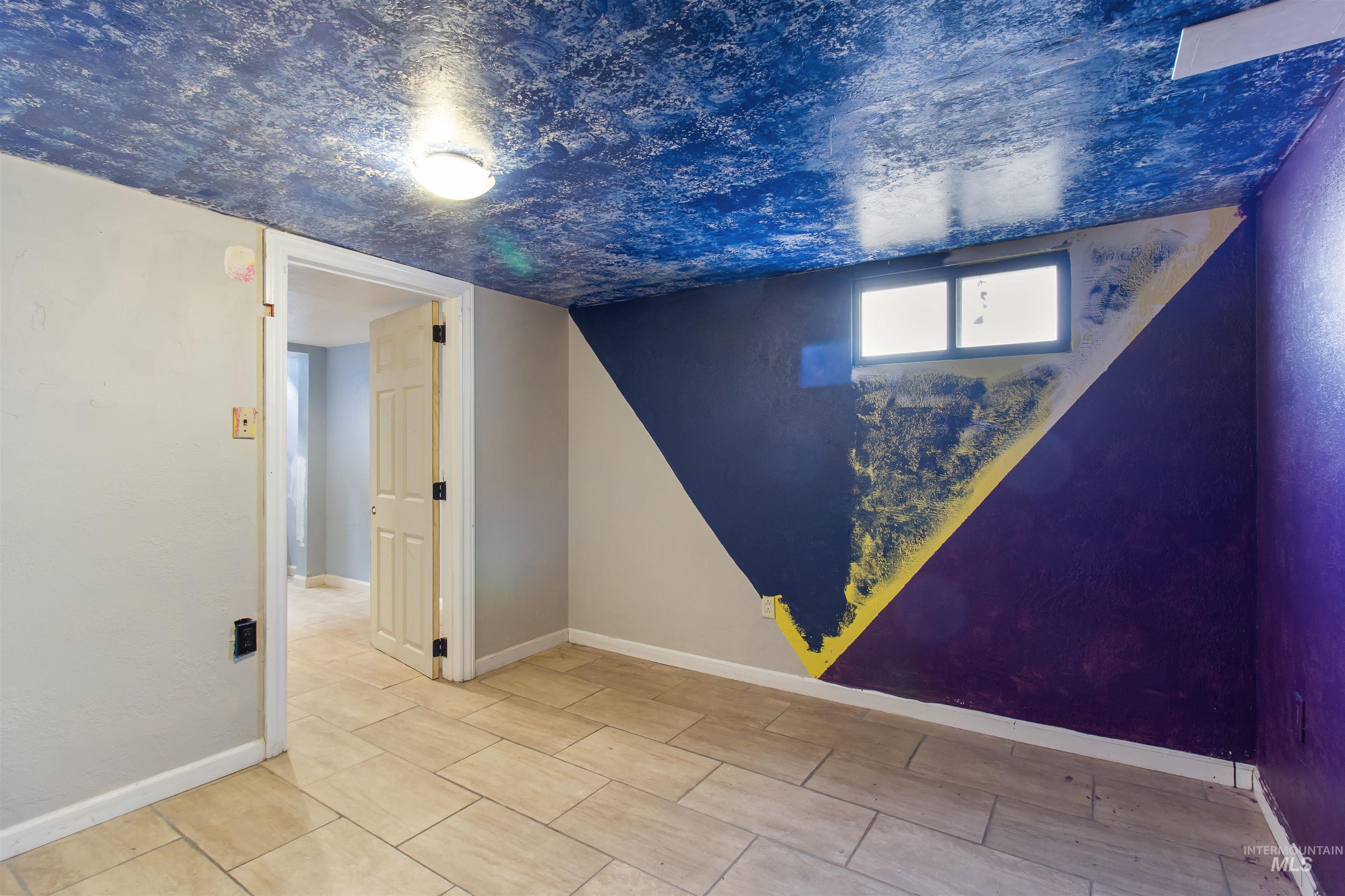 Below grade area featuring baseboards and a textured ceiling