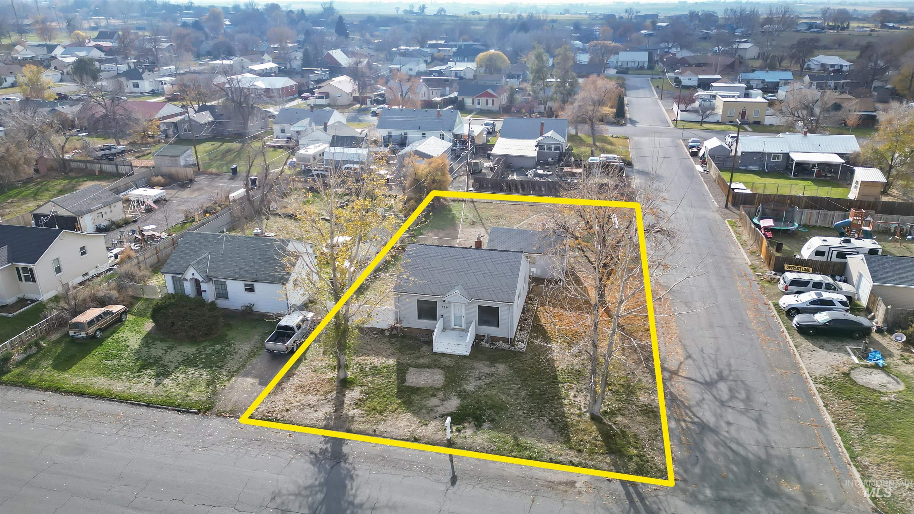 Aerial perspective of suburban area featuring property boundaries highlighted