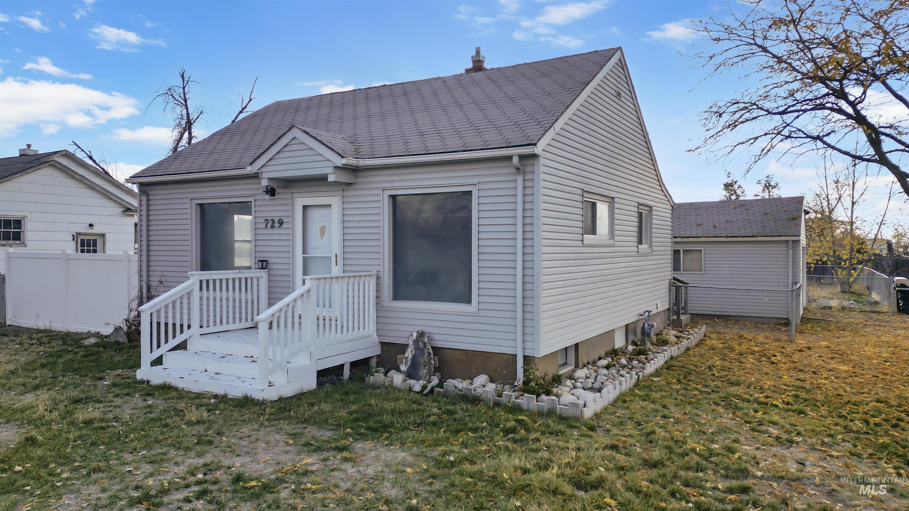 View of front of property featuring a wooden deck
