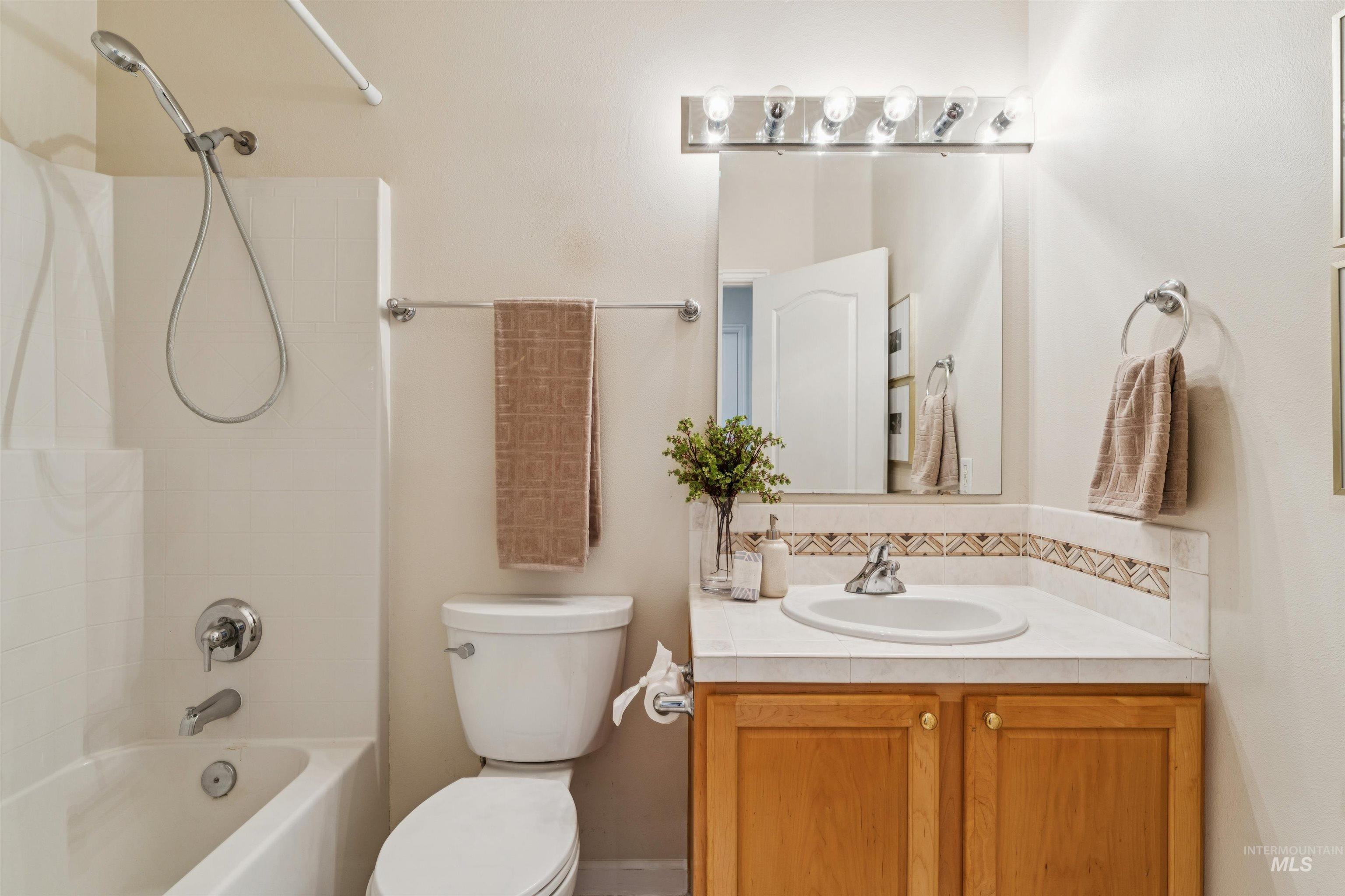 Bathroom featuring shower / tub combination and vanity