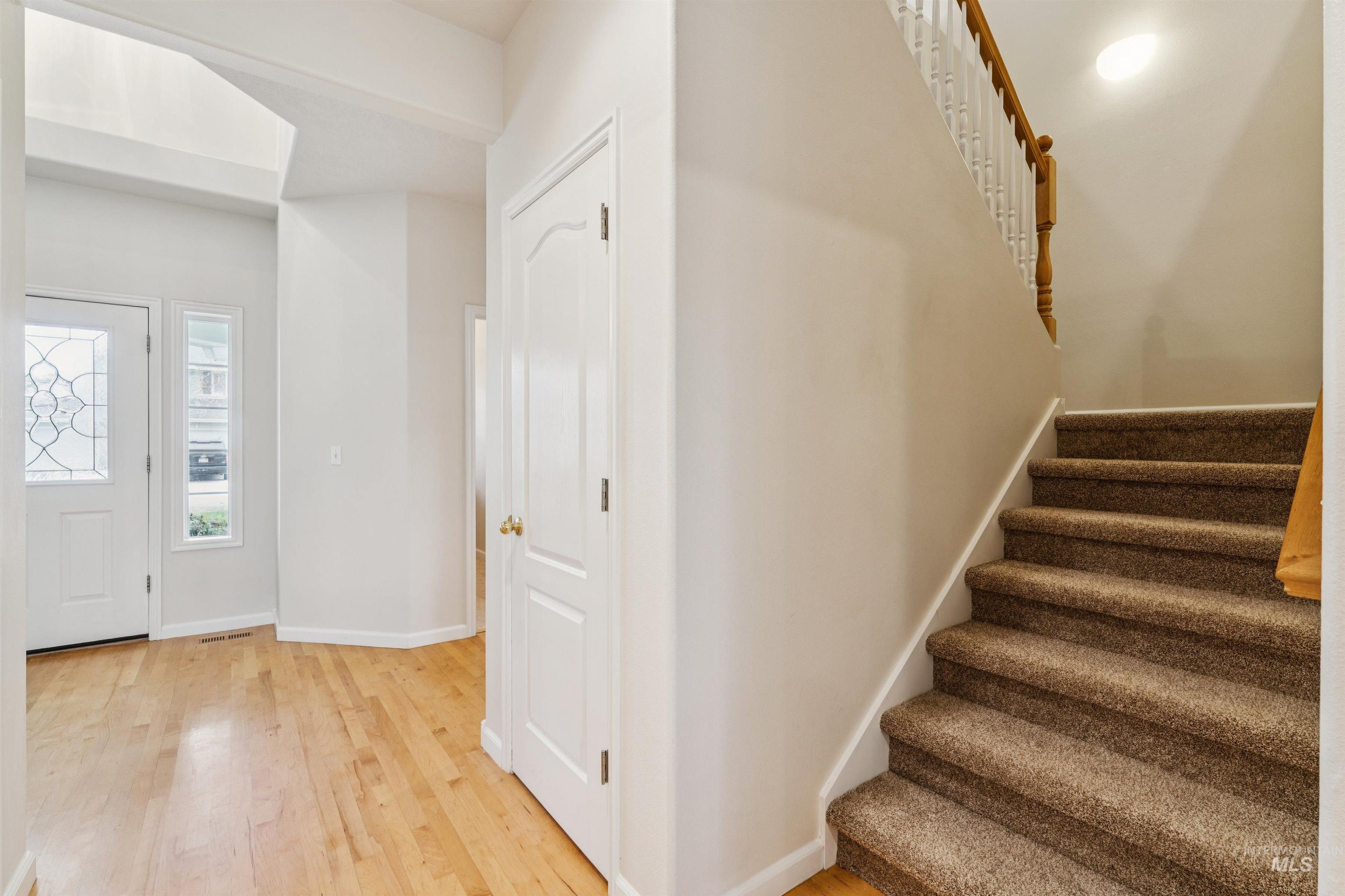 Entrance foyer with light wood finished floors and stairs