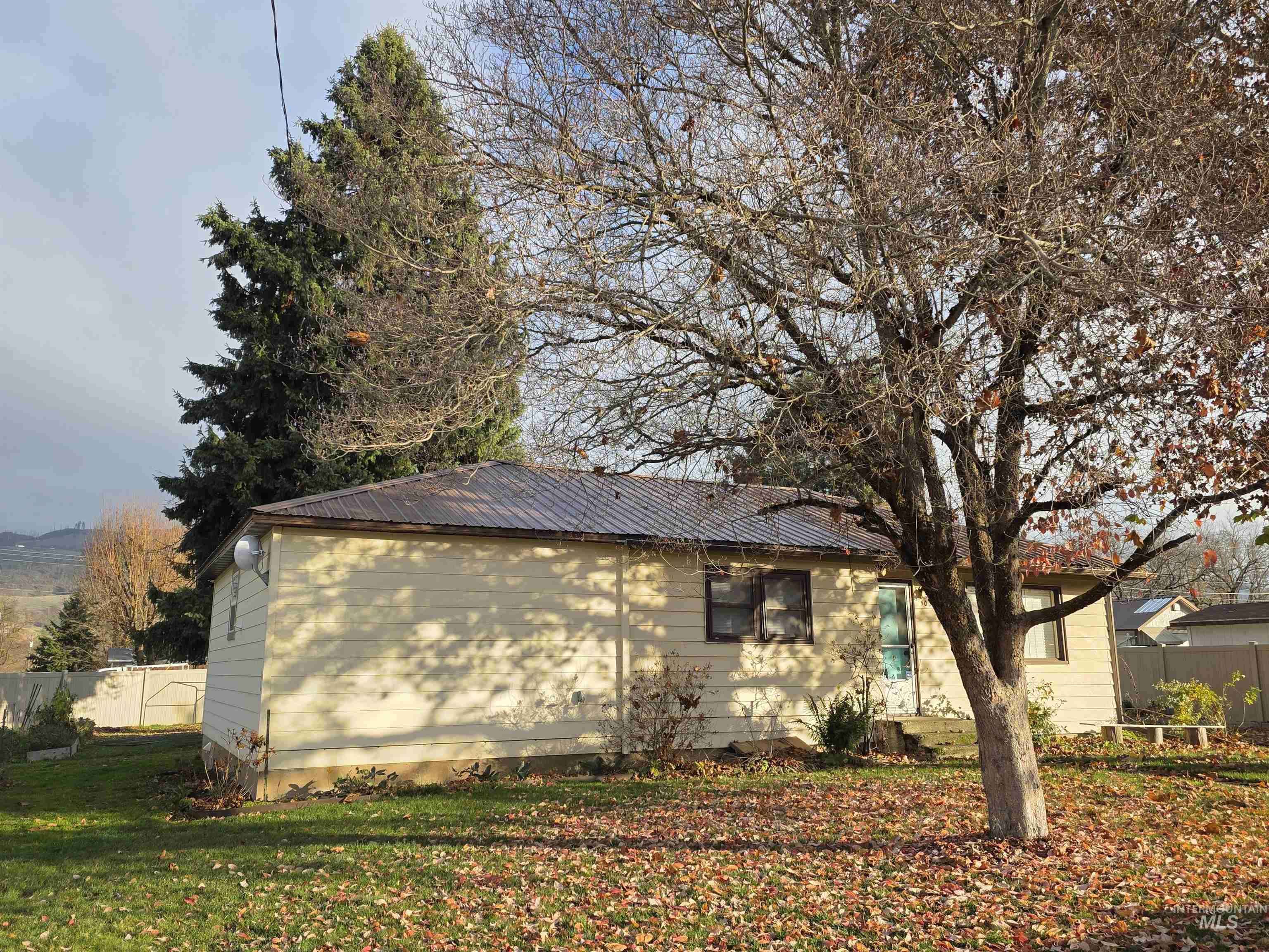 View of side of home with a metal roof