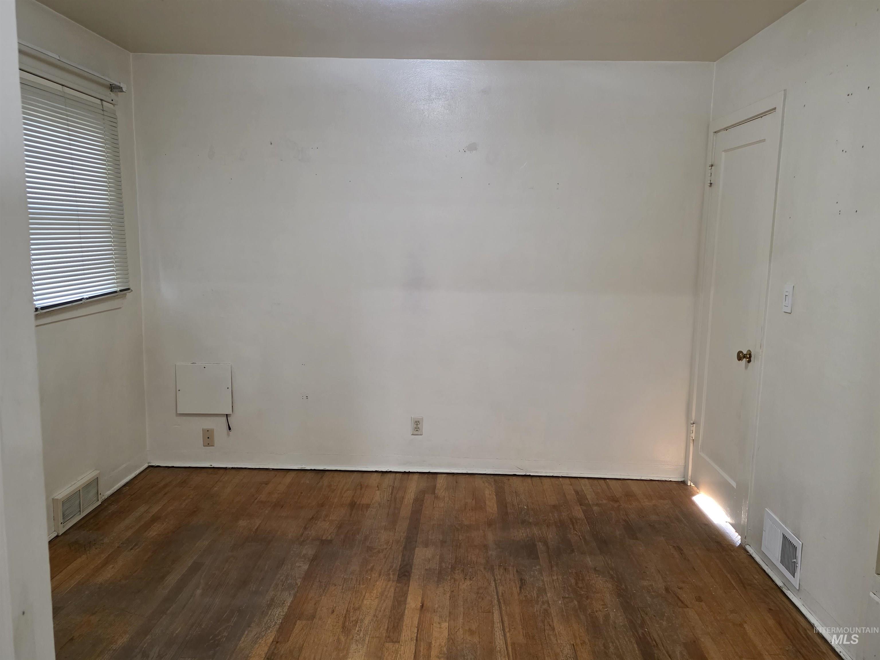 Empty room featuring dark wood finished floors